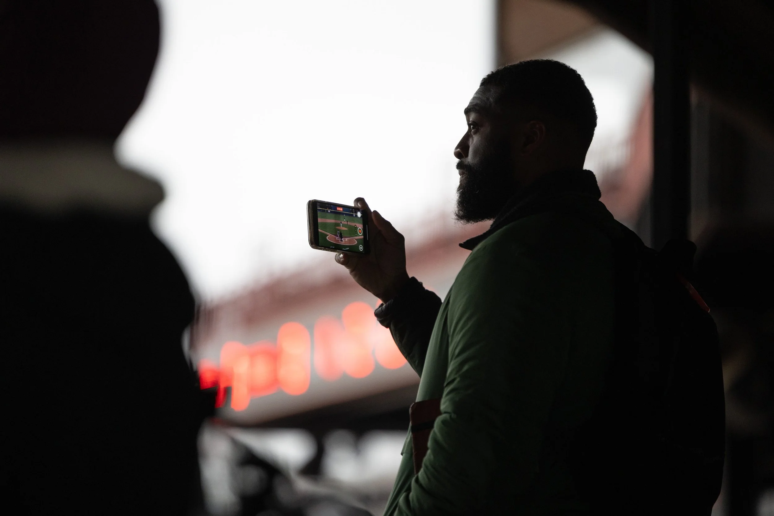 Stephen Octave, scout for the Chicago White Sox MLB team, records potential recruits on the field on Feb. 24, 2025. Octave played baseball in college at Franklin Pierce University. 