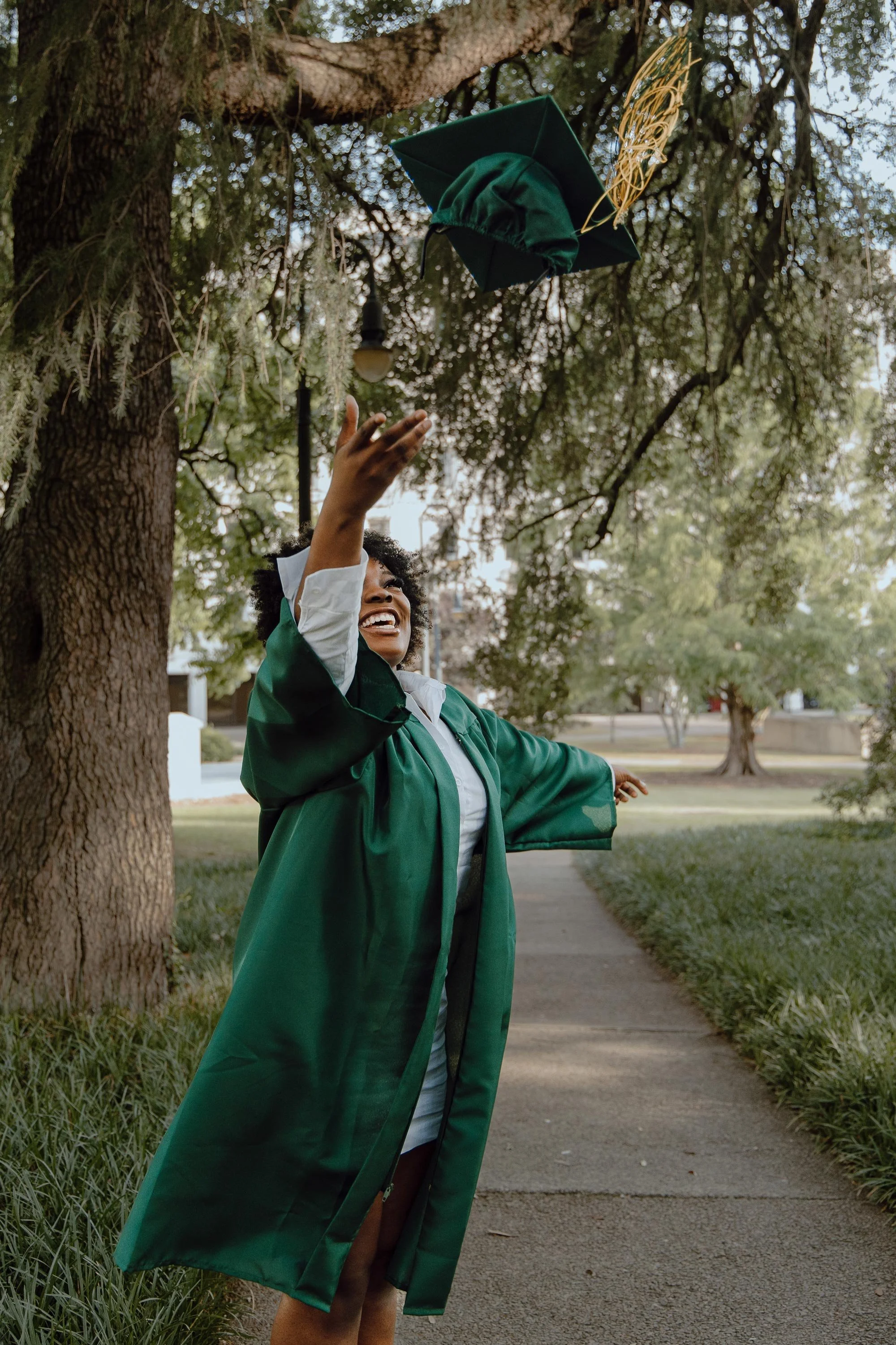 Kierra Rich tosses her cap while celebrating her graduation from Spring Valley High School in Columbia, South Carolina, on May 20, 2023.