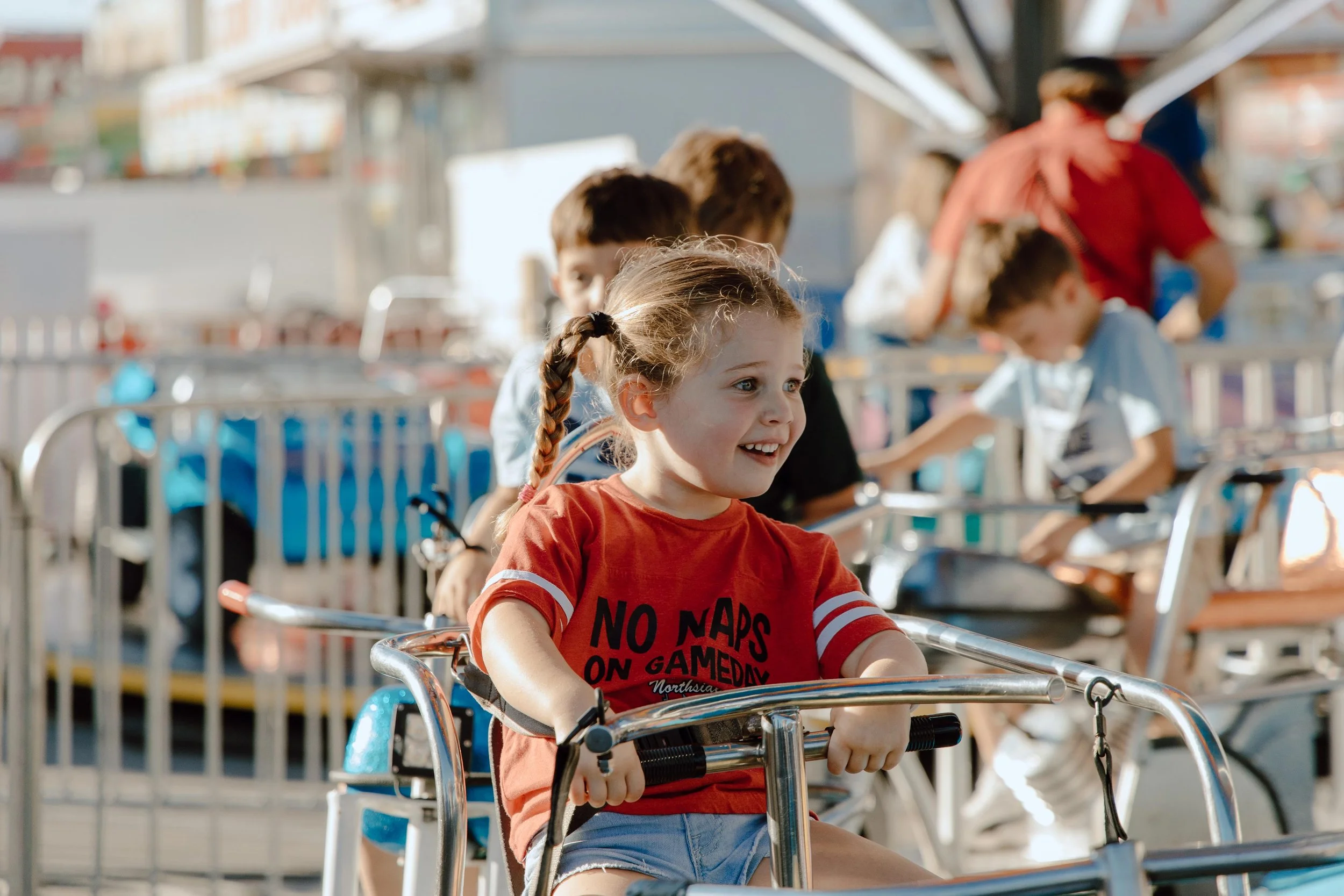 Fairgoer Collins, age 3,  says, "I wanna see!" and smiles on the Hampton Combo ride in Kiddie Land at the South Carolina State Fair on Oct. 12, 2024. The state fair has nearly 70 rides for a variety of fairgoers to enjoy from Oct. 9-20 this year.