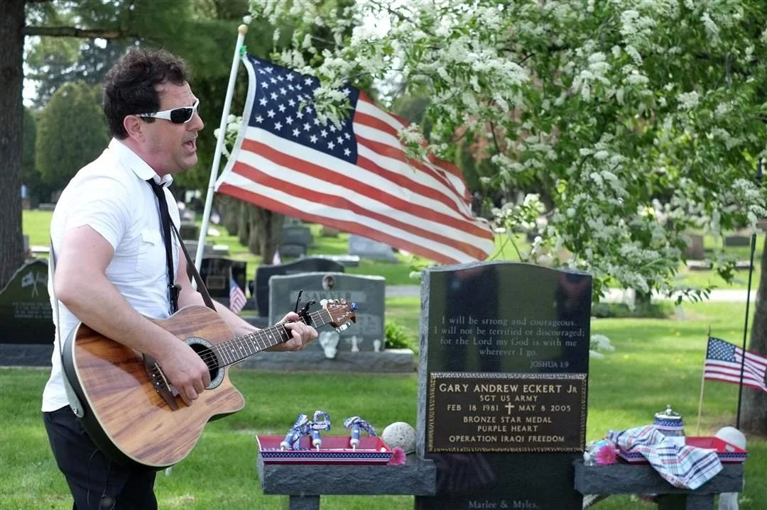 Scott Fish, lead singer of the band The Distant Cousinz, performs a song he wrote called "Marlee's Freedom" for Sgt. Andy Eckert's daughter Marlee.