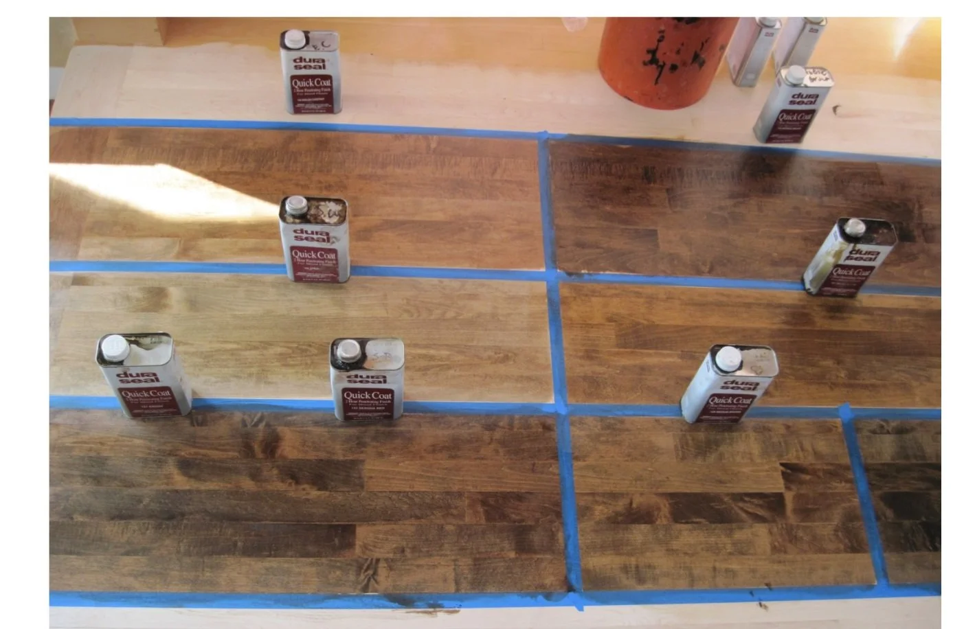 Samples of stain colors on hardwood floors for customer approval