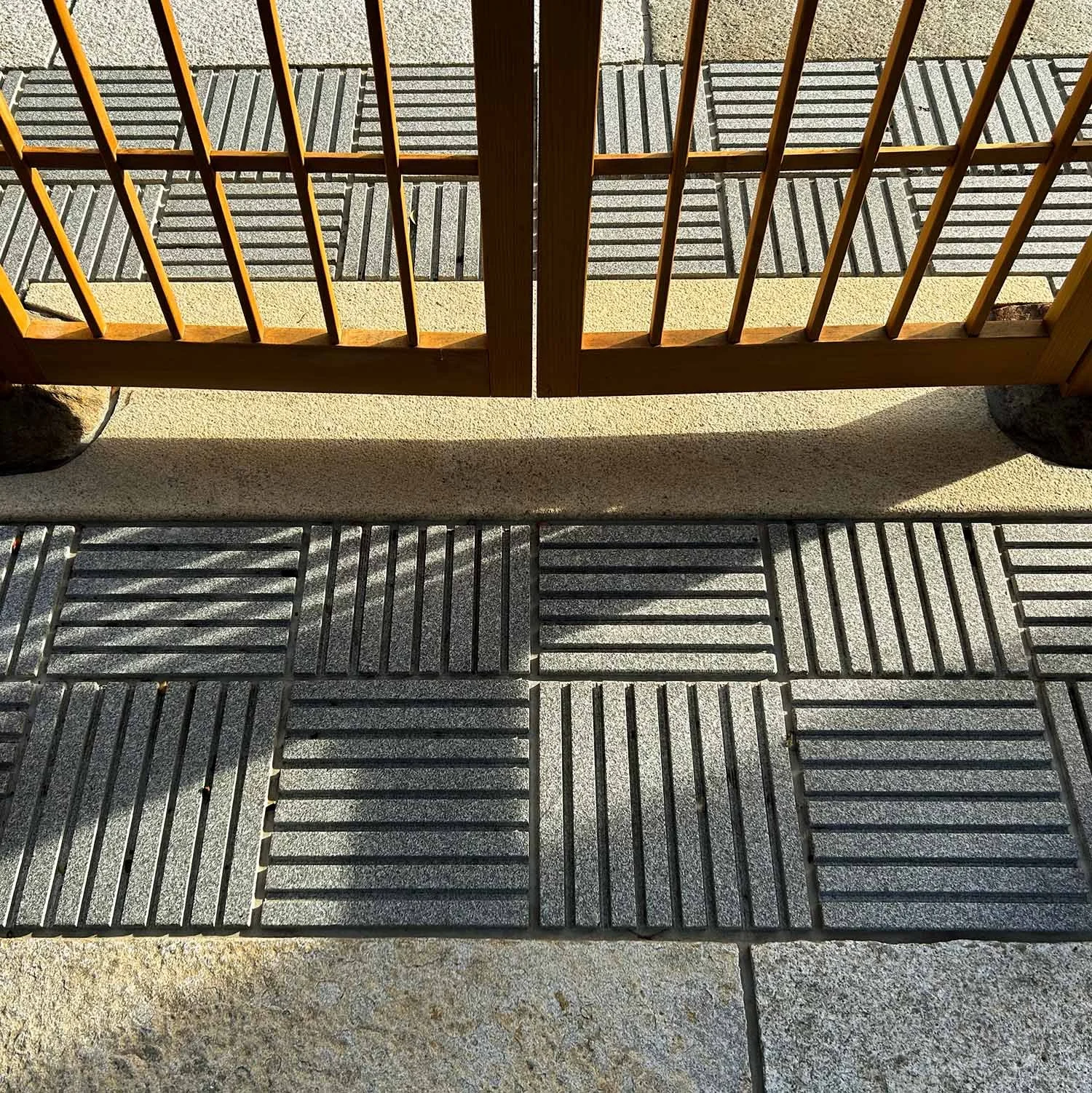 Modern Treatment of Paving Area Under Japanese Wooden Garden Gate