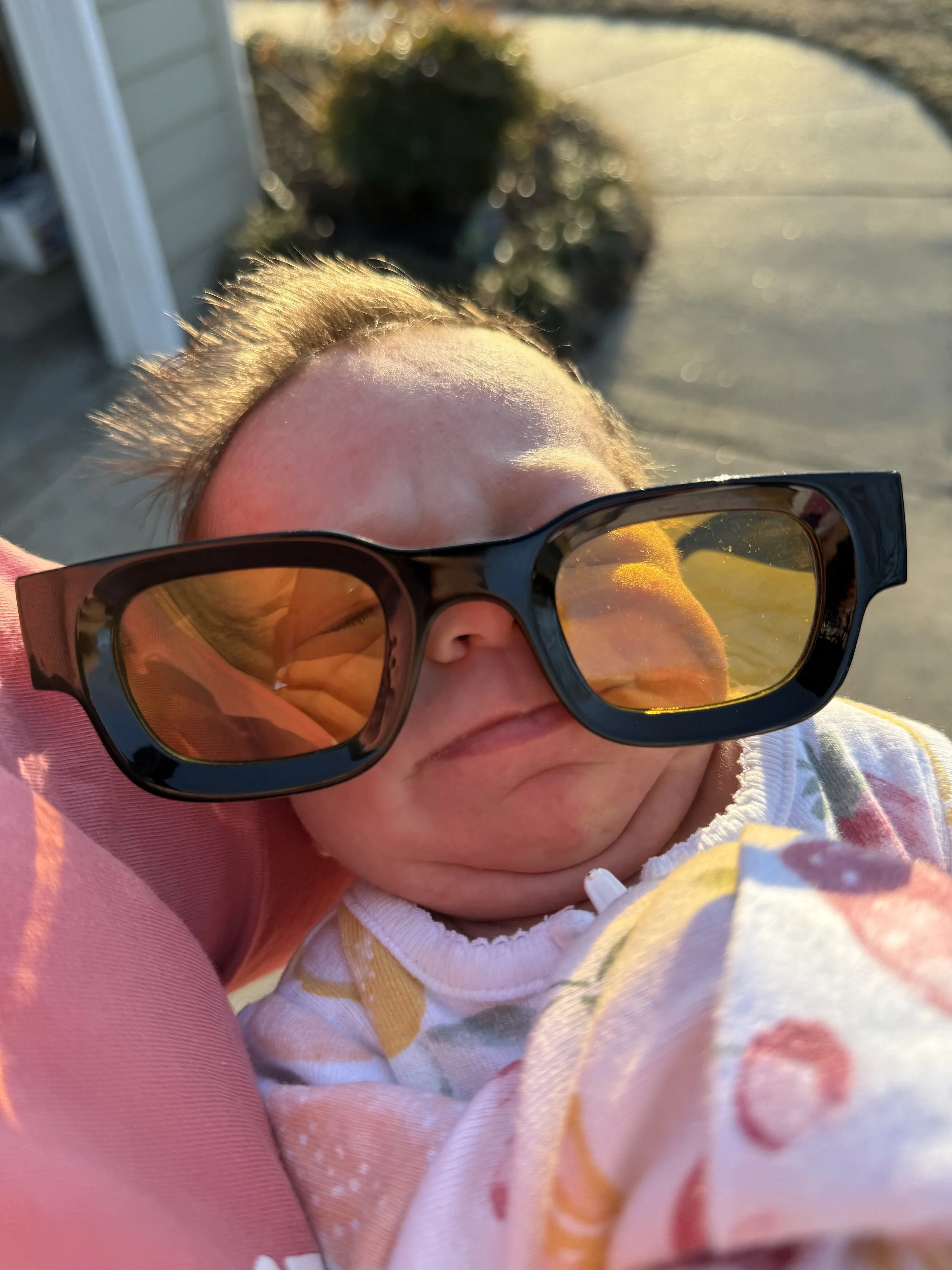 Young baby wearing funky orange sunglasses