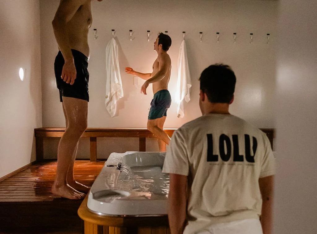 Lolu crew gather around the communal cold plunge in a guided hot + cold session