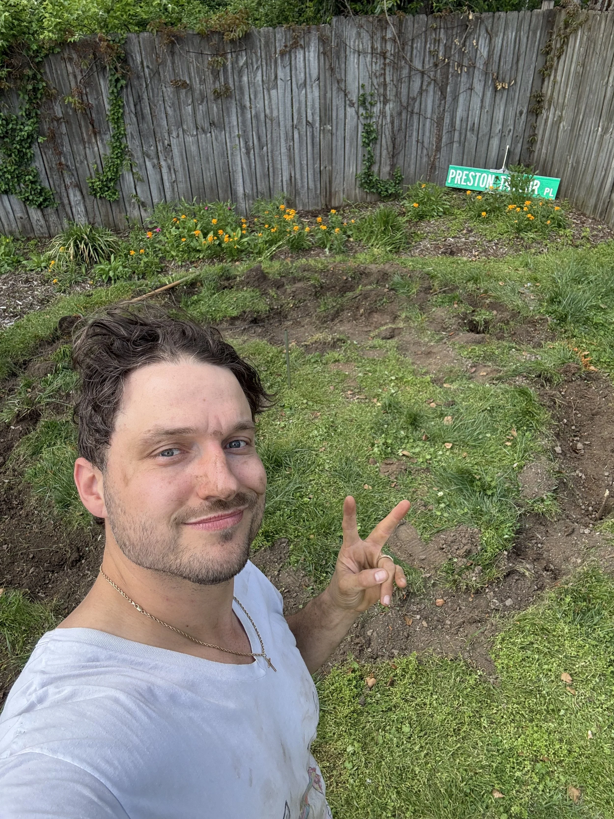 Guy digs deep for firepit build at Airbnb property