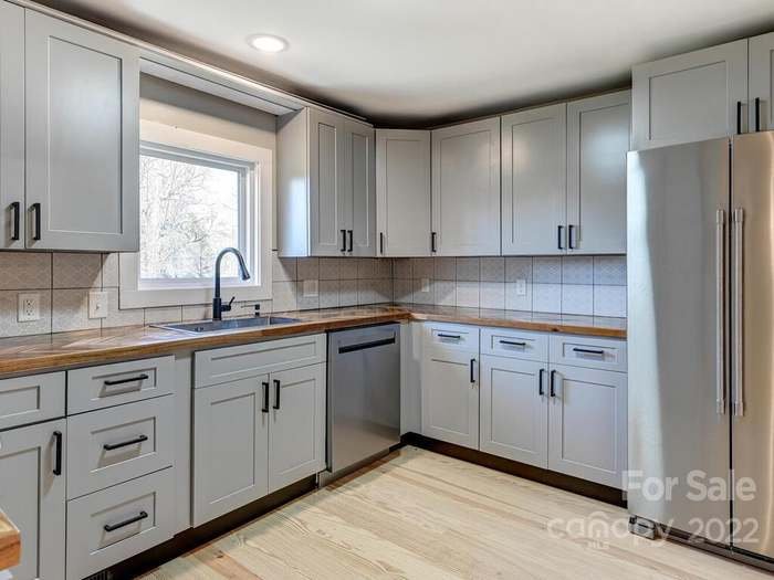 Kitchen view from laundry room and bathroom area 