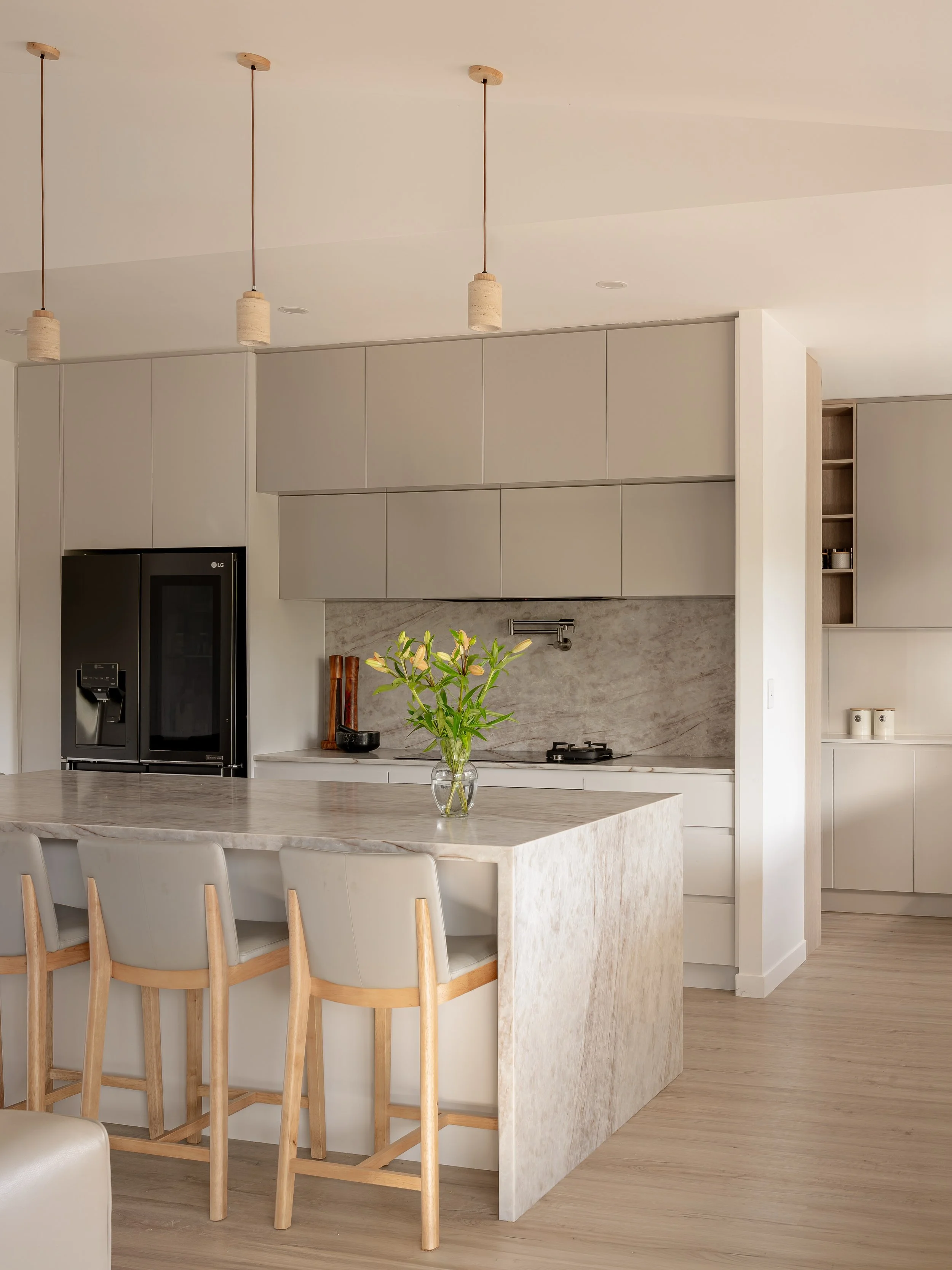 Pinewood Kitchen - 

A bright open kitchen designed around everyday living. Streamlined handless cabinetry, generous storage and a large curved stone island bench creates a space that&rsquo;s practical, welcoming and made to be enjoyed. 

Fully desig