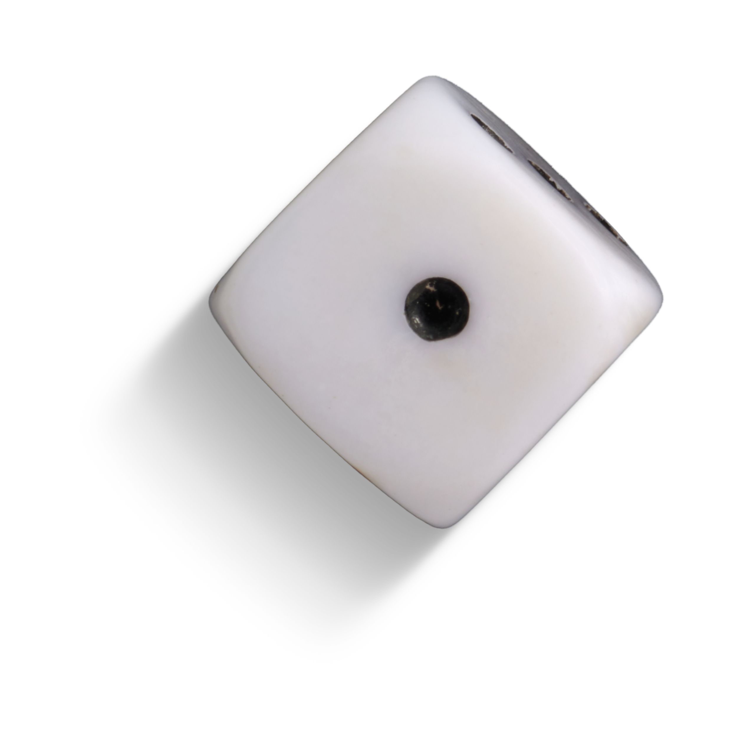 A white die with black dot
