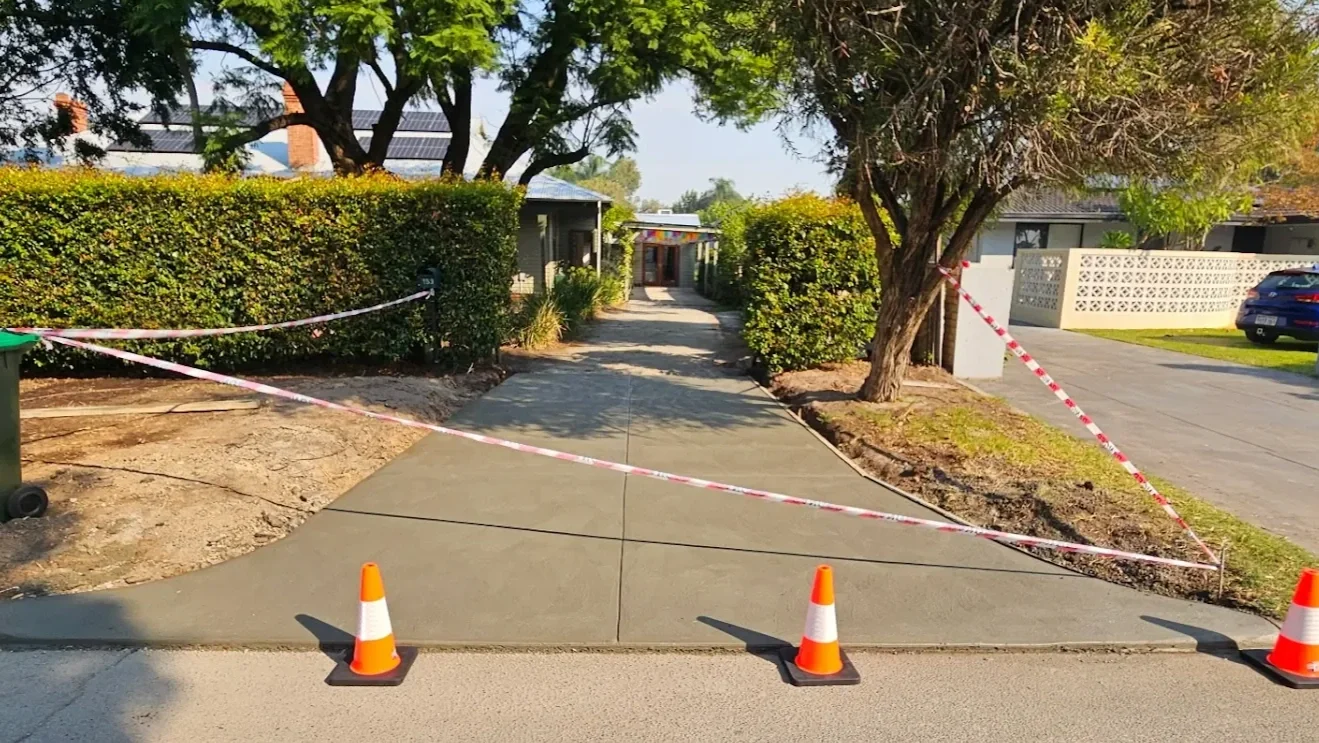 Grey concrete crossover and driveway poured in Bassendean