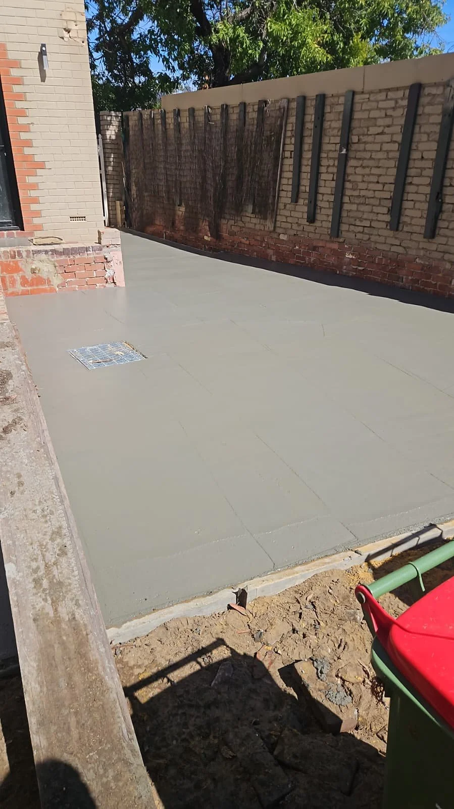 Fresh grey concrete pour in progress for Attadale car port
