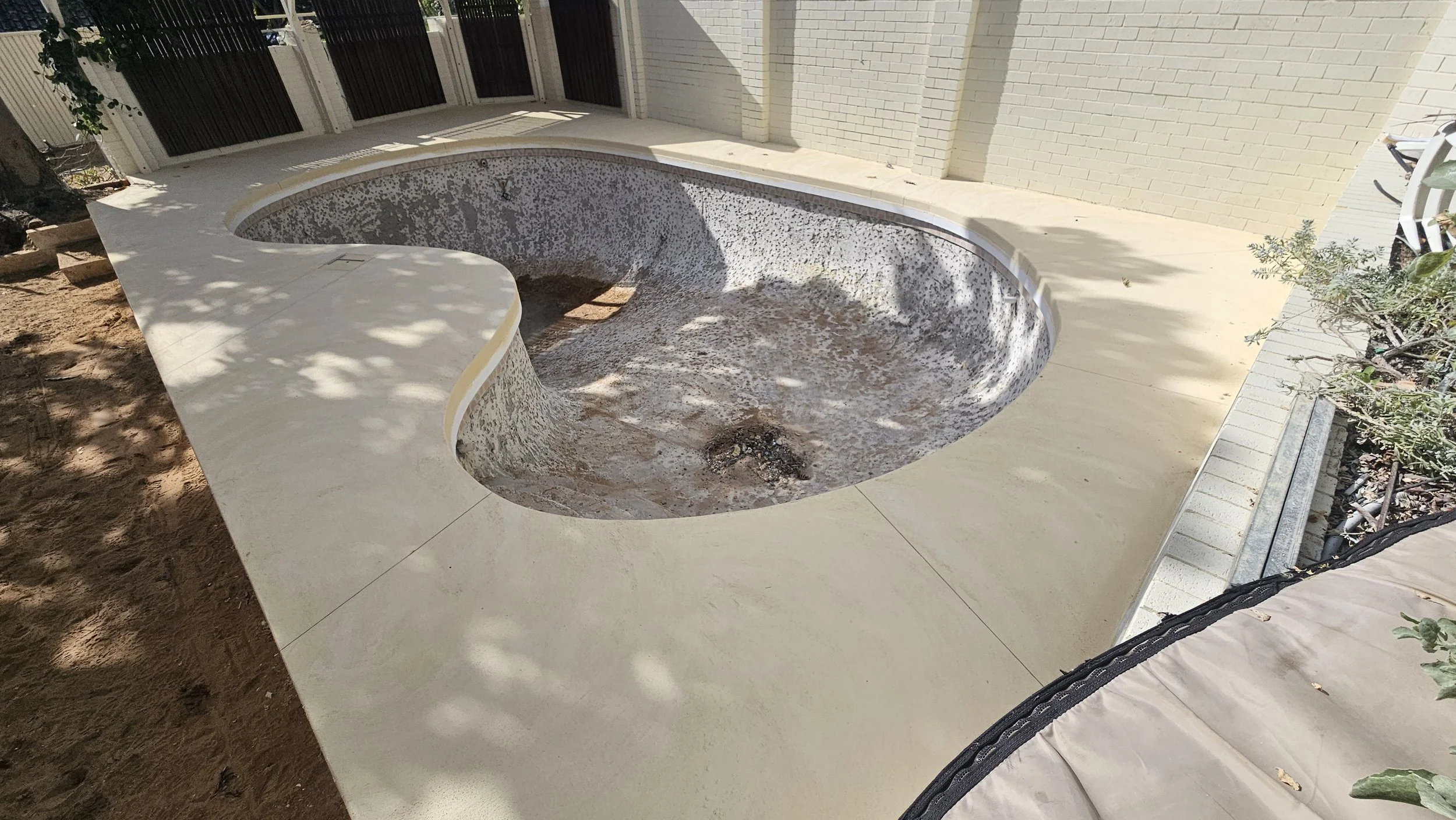 liquid limestone pool surrounds poured and finished with lines cut in Bicton