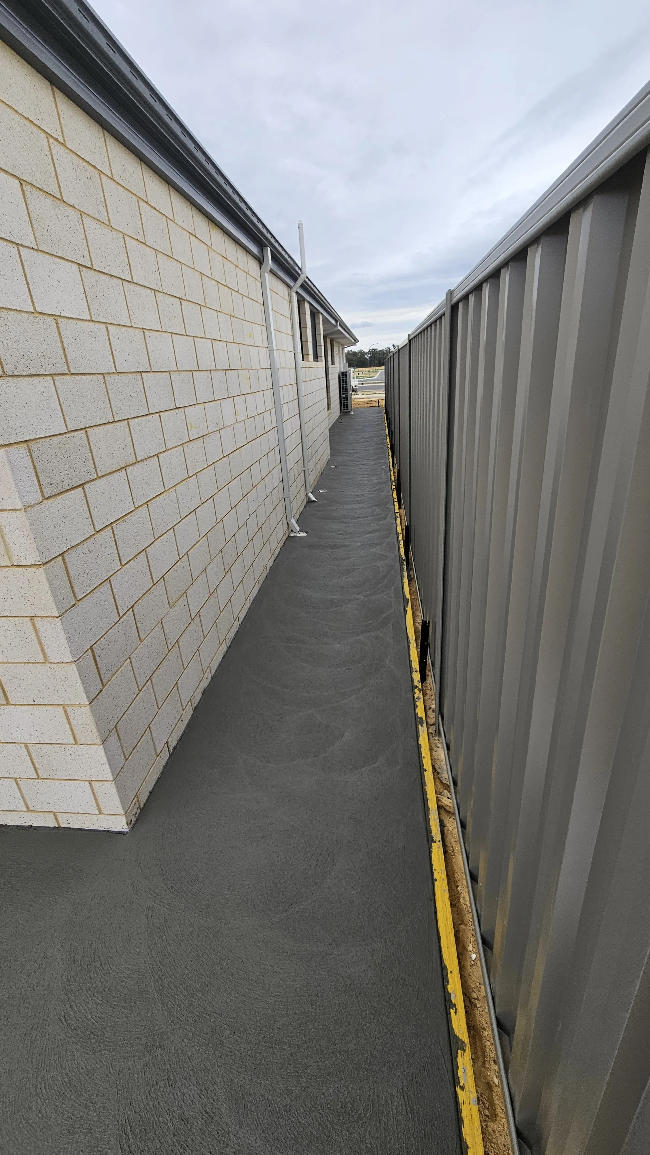 Grey concrete house surrounds and house footpaths in Byford