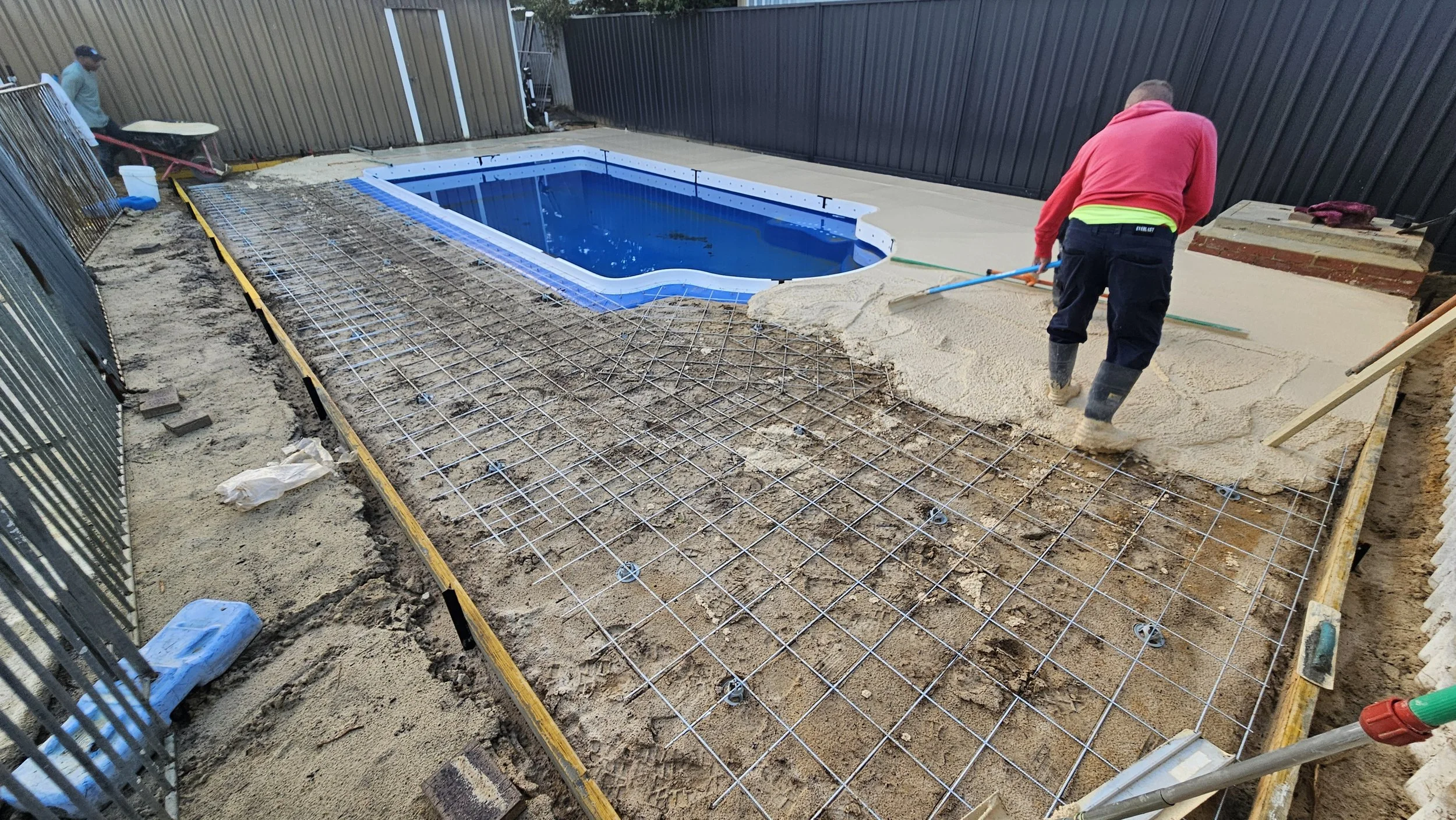 Pouring liquid limestone concrete to pool surrounds in Forrestfield