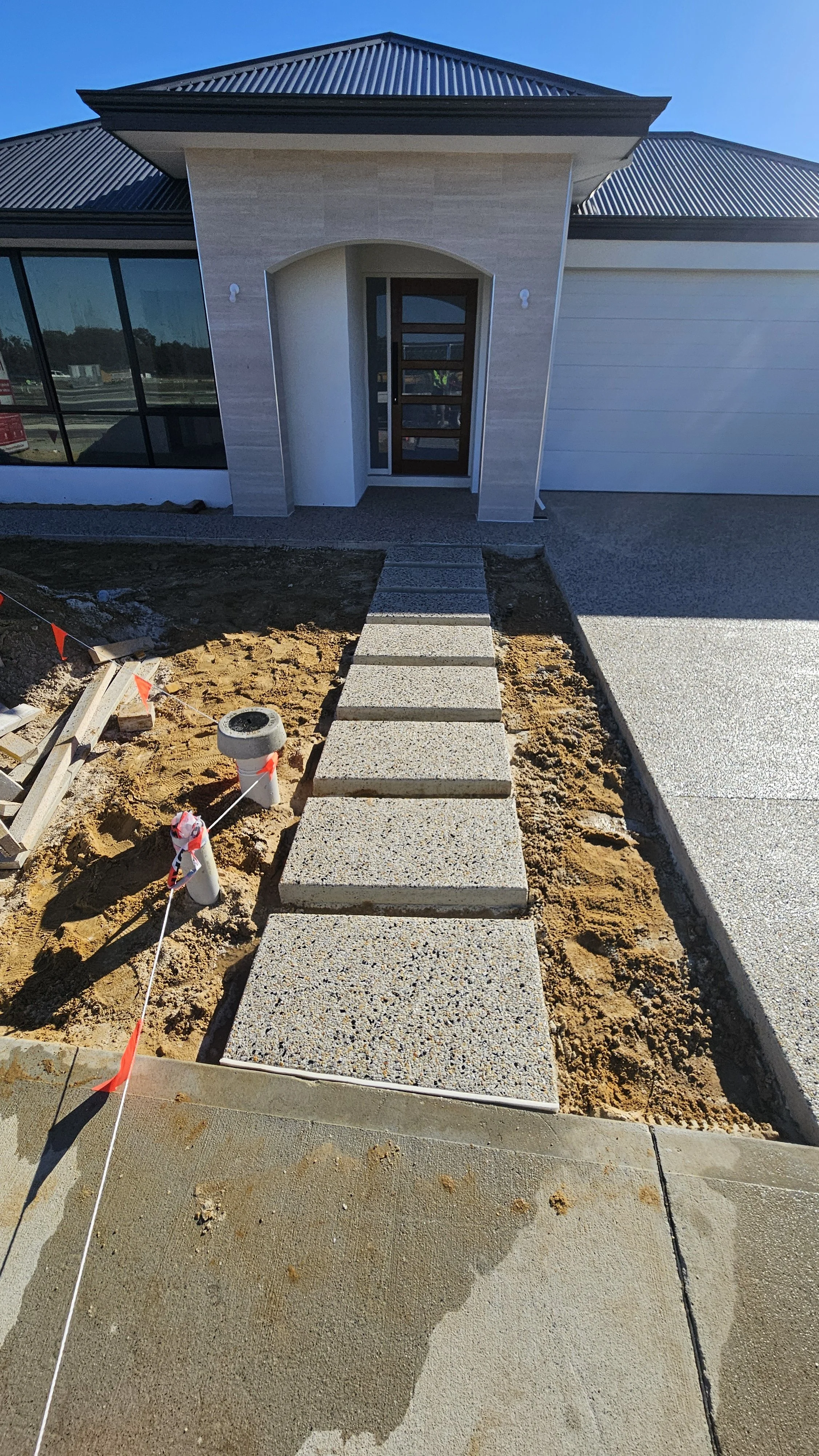 exposed aggregate stepping stones in Byford next to driveway