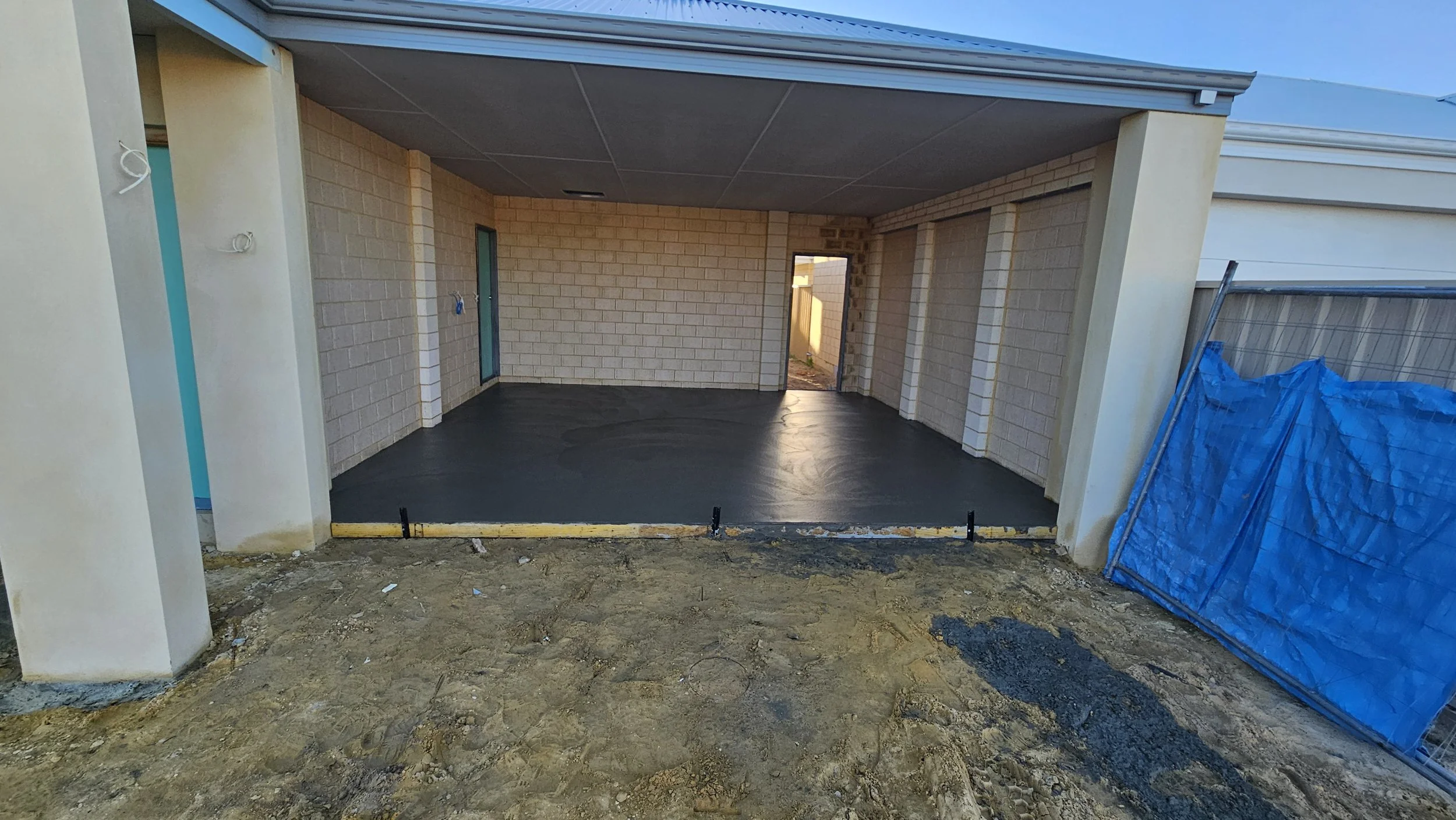 freshly poured grey concrete to garage in Southern River