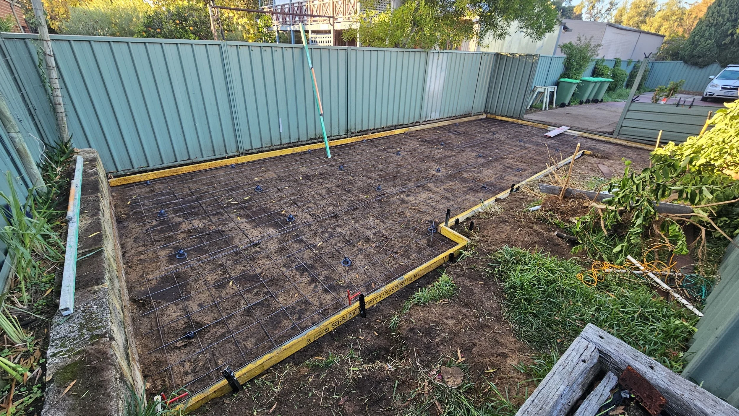 Grey concrete shed slab site preparation mesh reinforcement in Palmyra