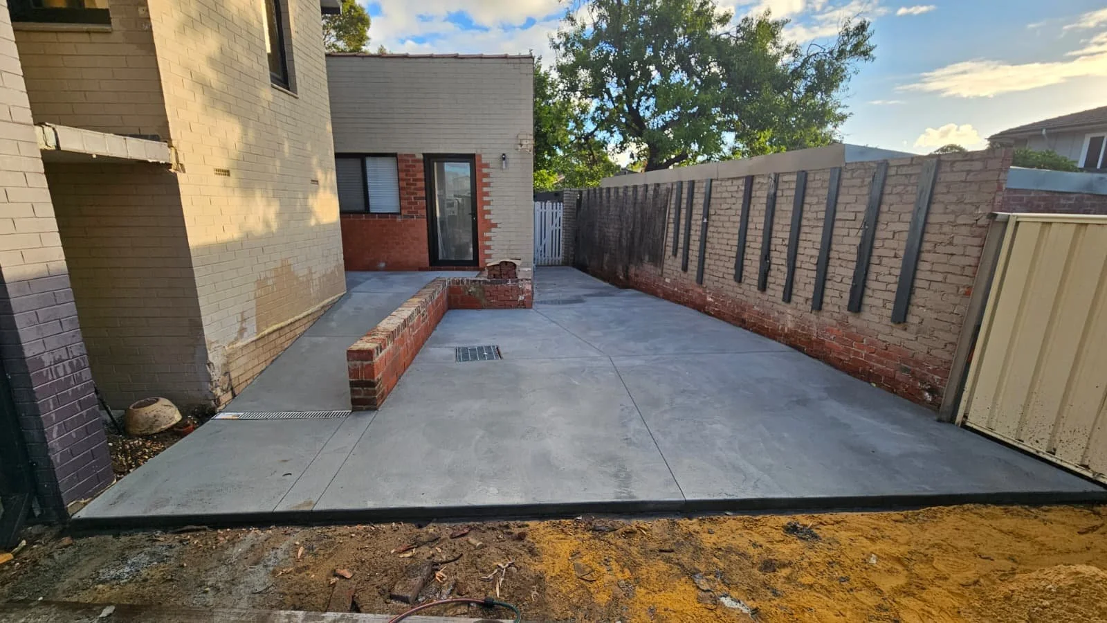 Grey concrete carport garage slab and NDIS ramp for Attadale project
