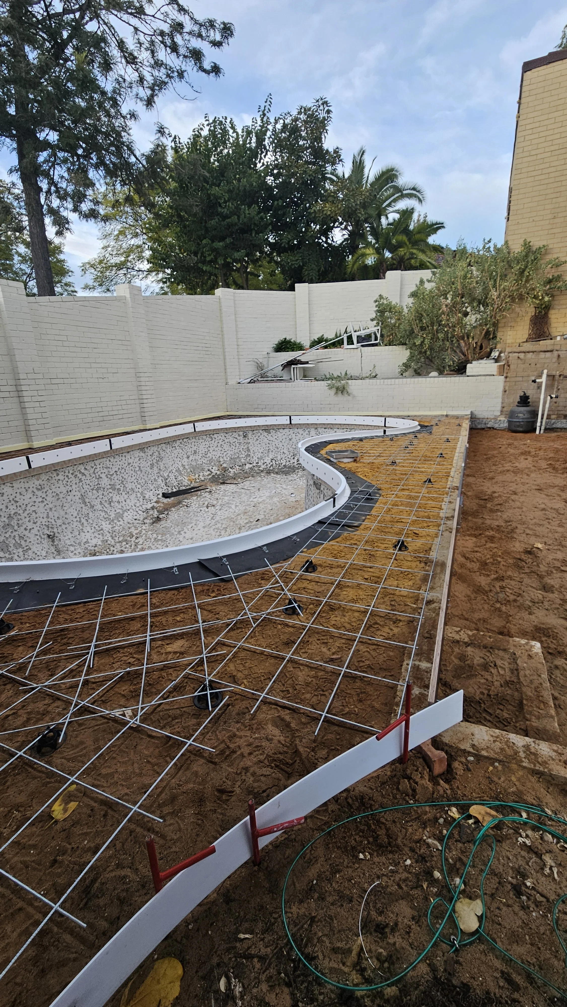 Set up and reinforcement for preparation to liquid limestone pool surrounds pour in Bicton