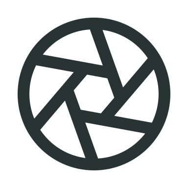A black circular pattern resembling a camera shutter or aperture with multiple overlapping segments.