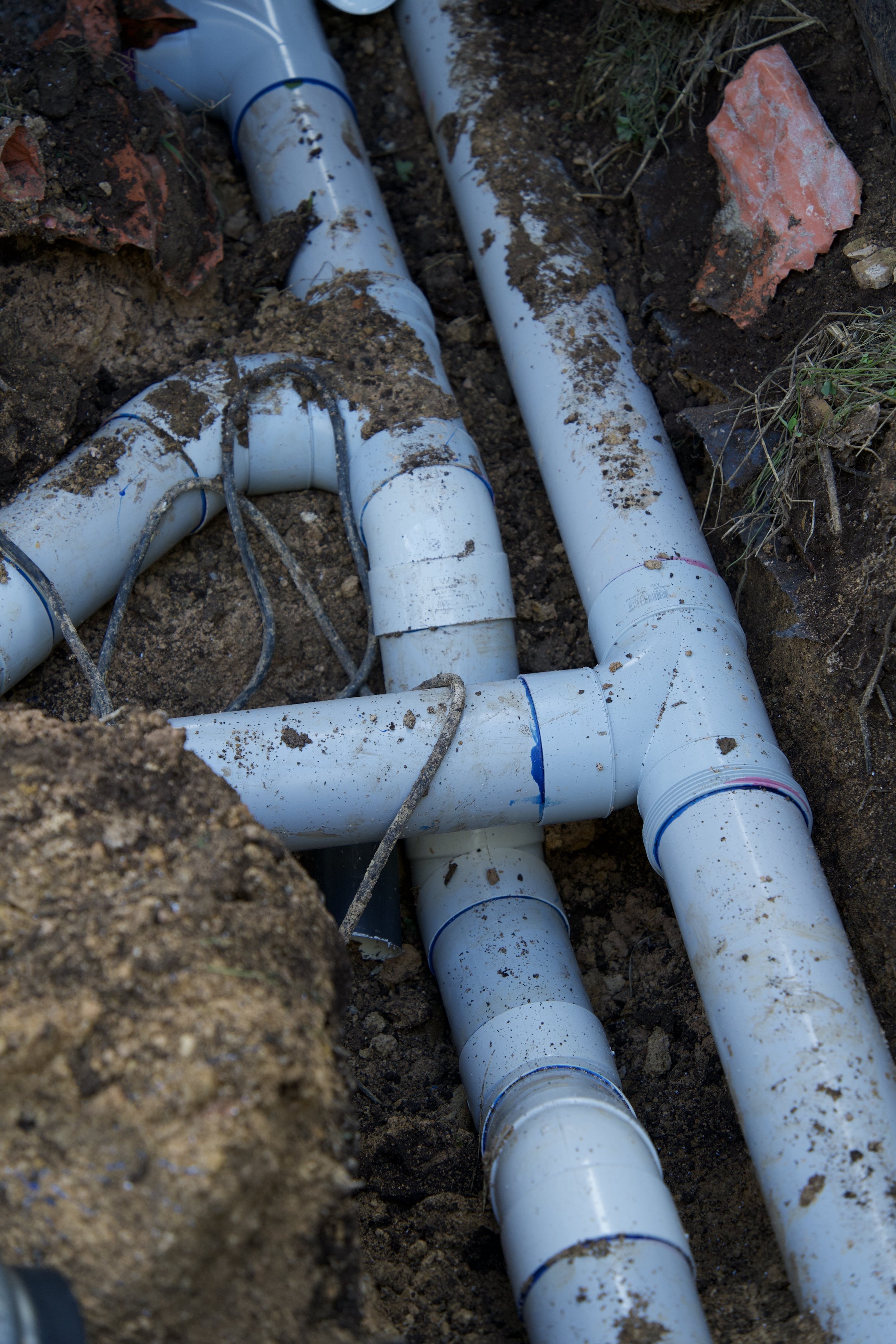 Plumber repairing a leaking water pipe in an Adelaide home