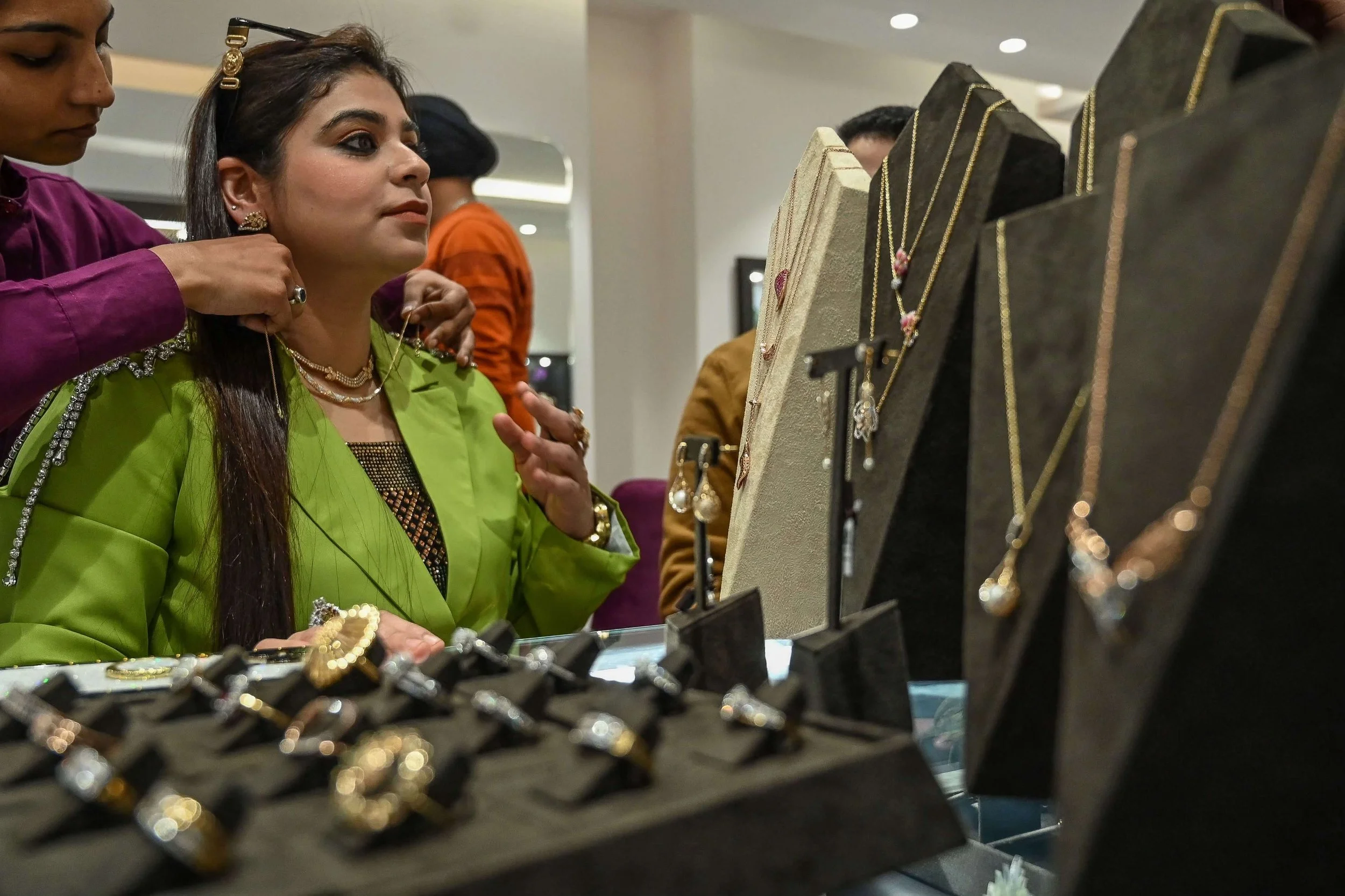 A woman tries on jewellery in a CaratLane store in Punjab.