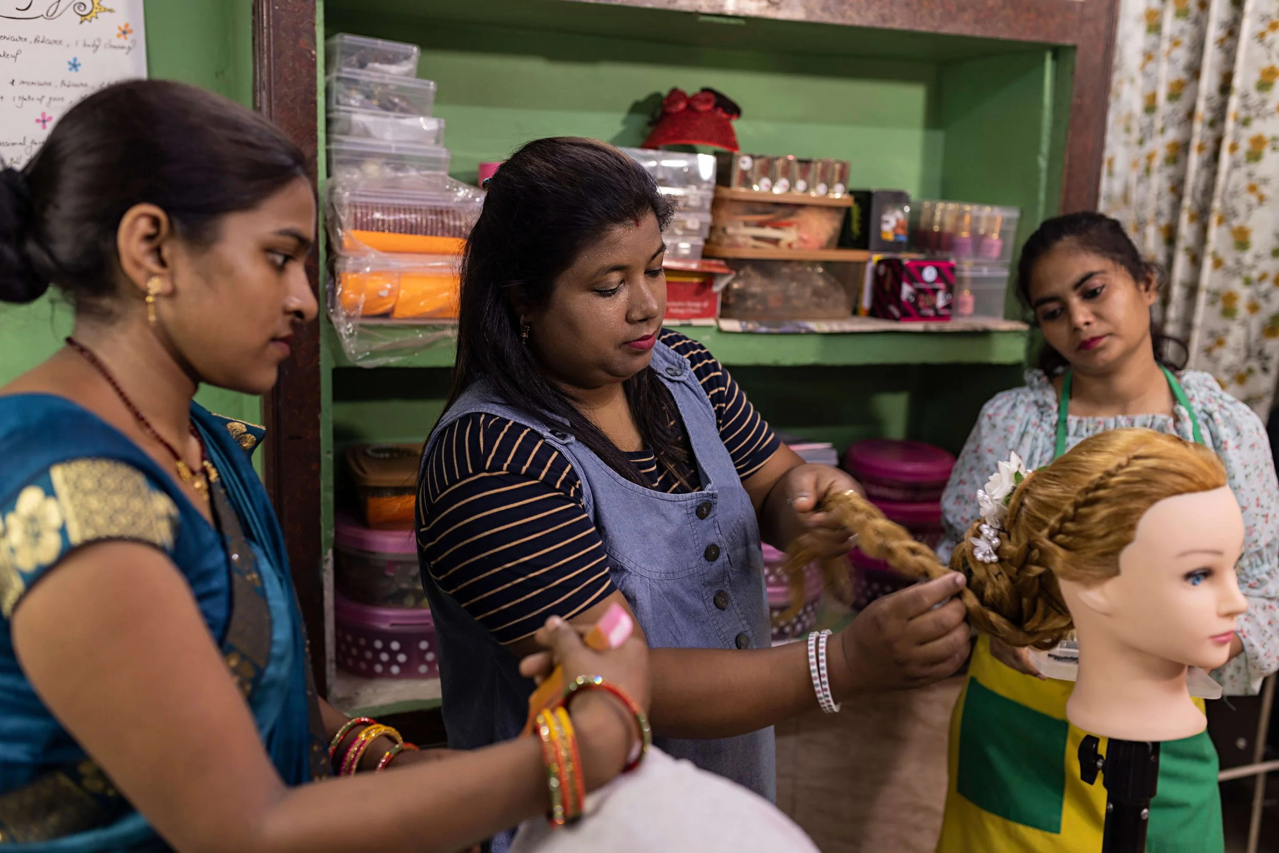 Women training in a beautician's course. Getty Images.