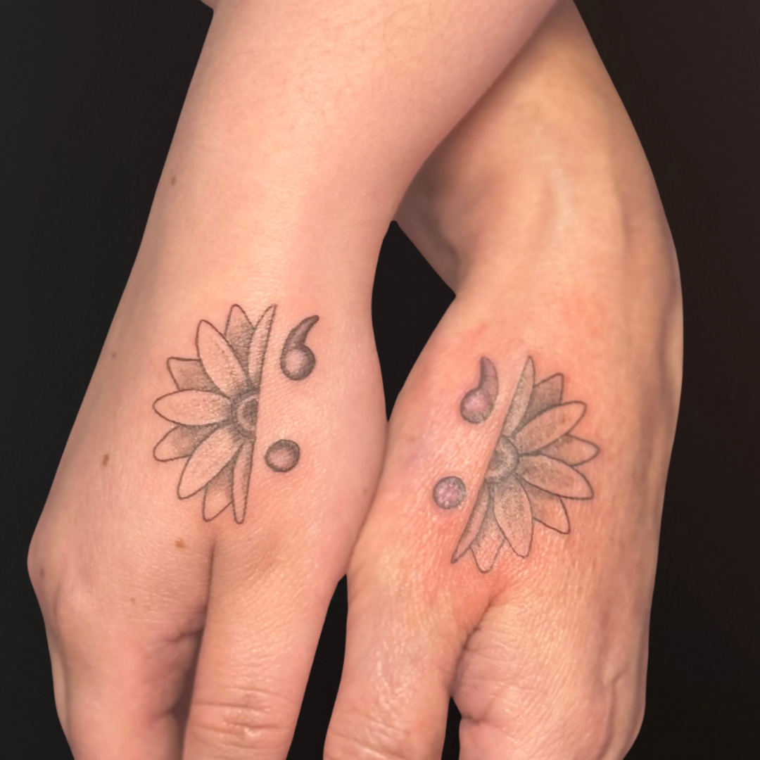 Matching Flower Comma Hand Tattoos.png