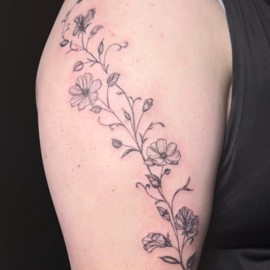 Fine Line Floral Tattoo On Bicep.png