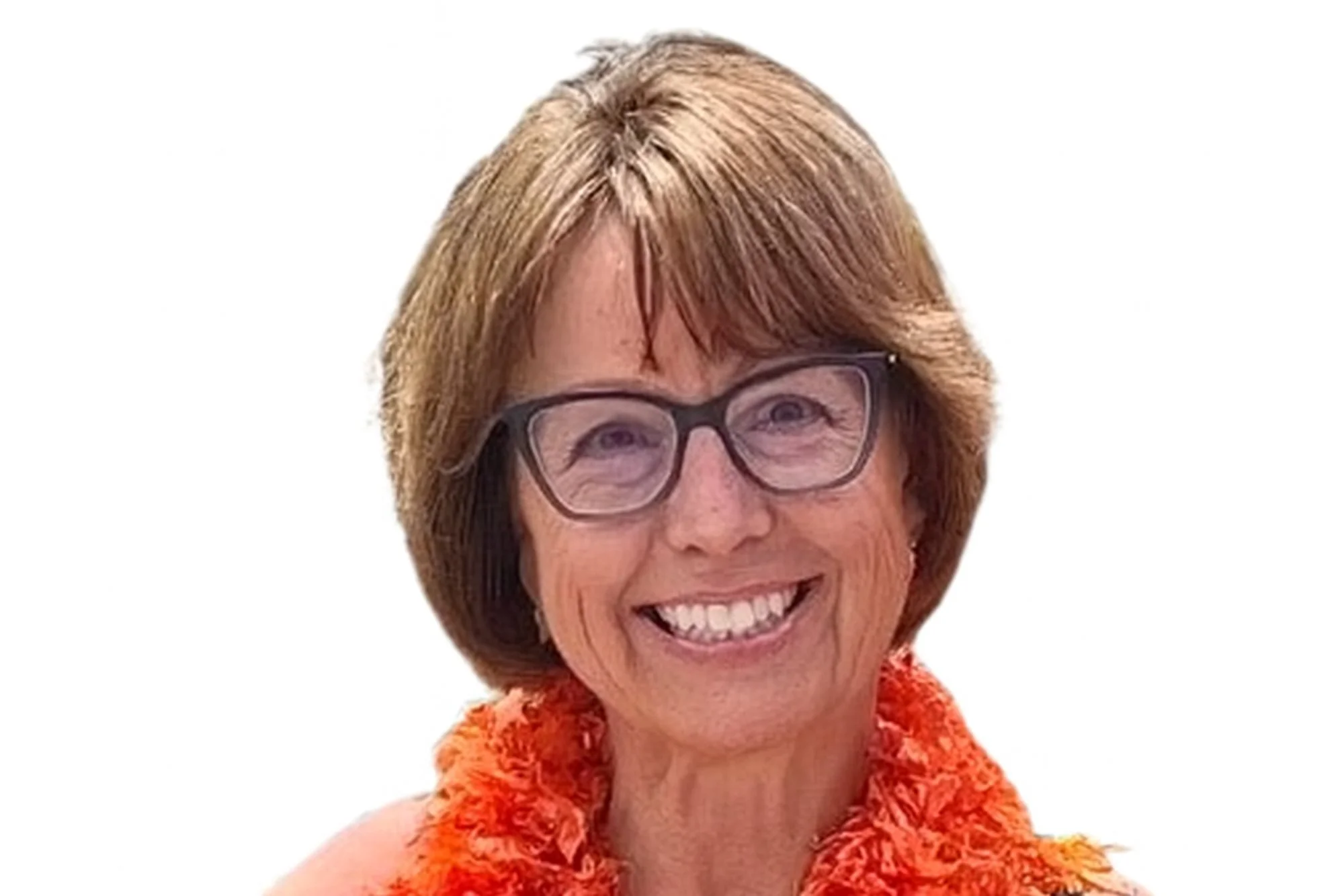 A smiling middle-aged woman with short auburn hair, wearing glasses and an orange textured sleeveless top.