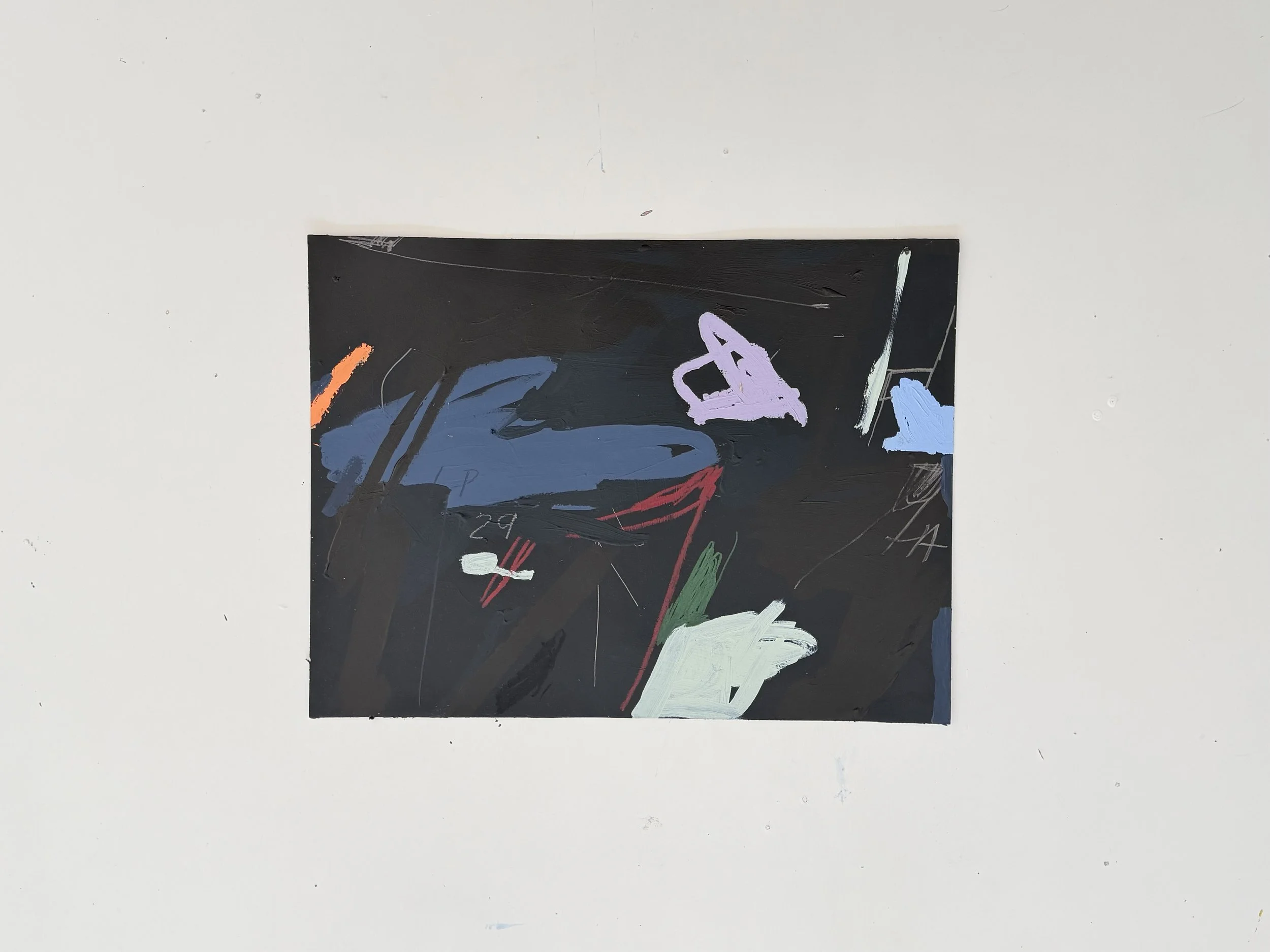 Abstract painting with various colors including purple, blue, white, red, orange, green, and black on a black rectangular background, placed on a white surface by Aura Delamotte.