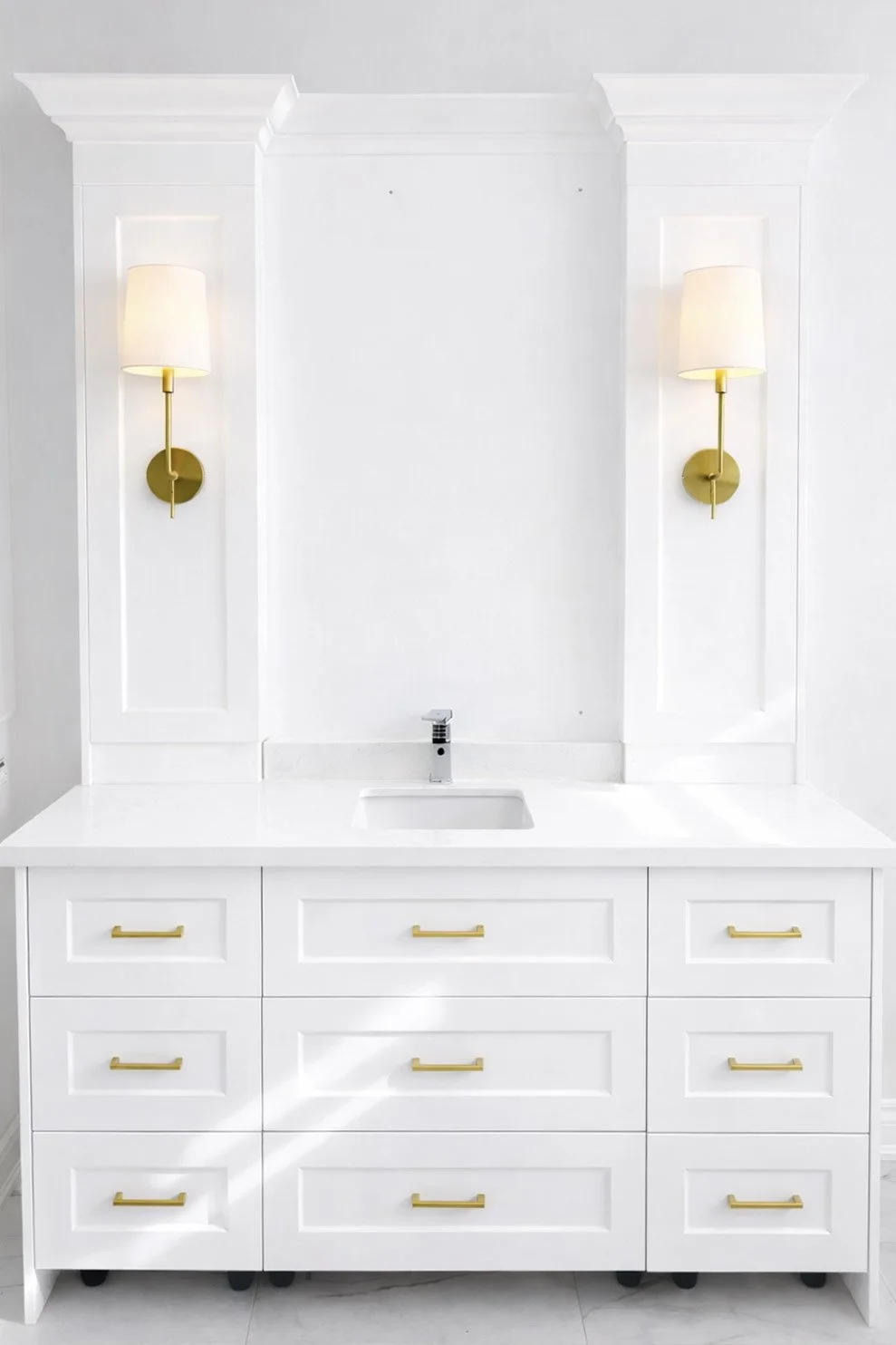 Bathroom vanity with brass sconces.jpg