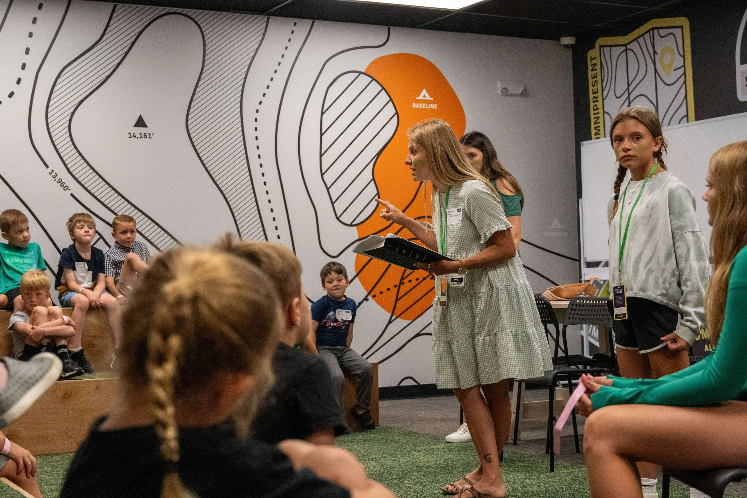 A kids camp volunteer teaching the bible to kids at camp!