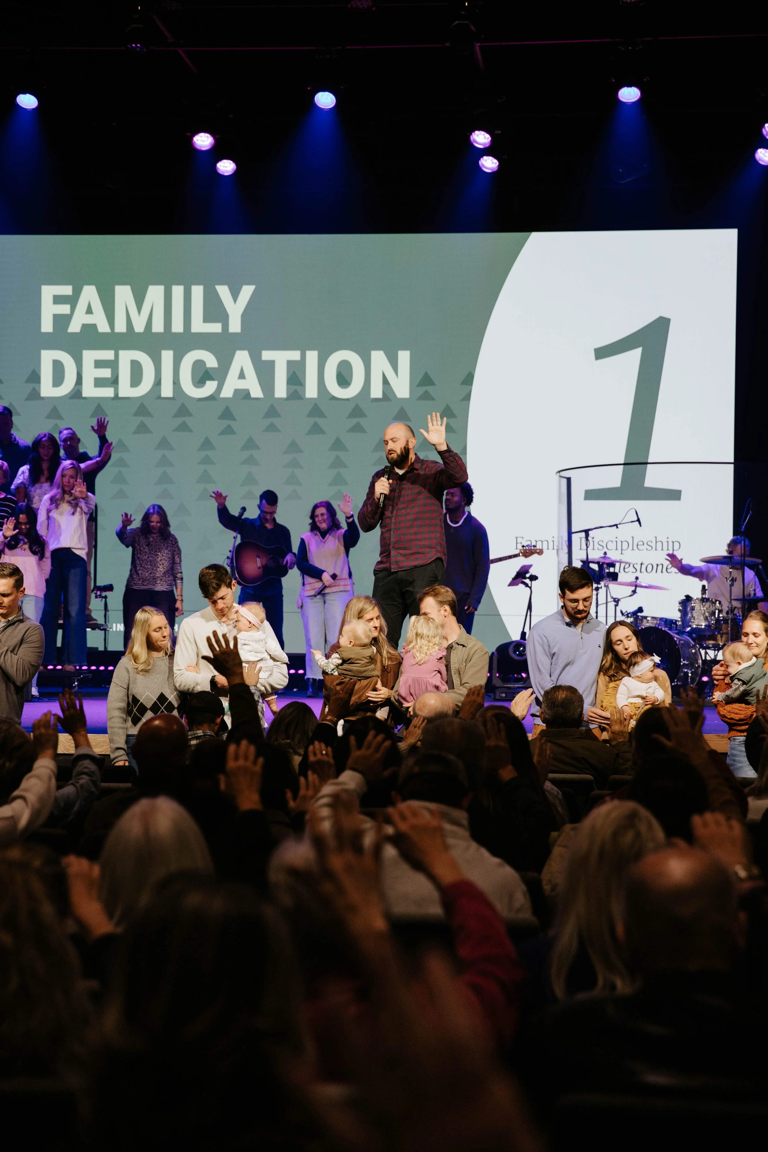 Young families dedicating their children to the Lord at a Family Dedication service at Storyline Church in West Arvada. 