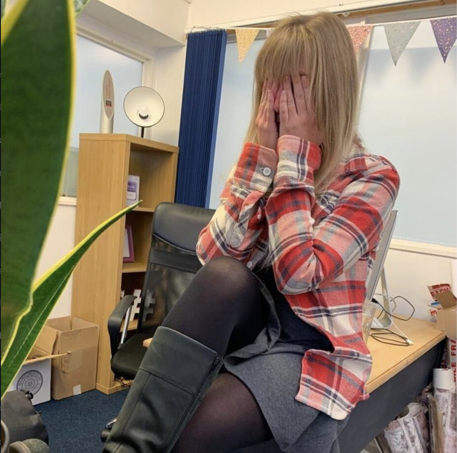 Katherine George covering eyes in pain