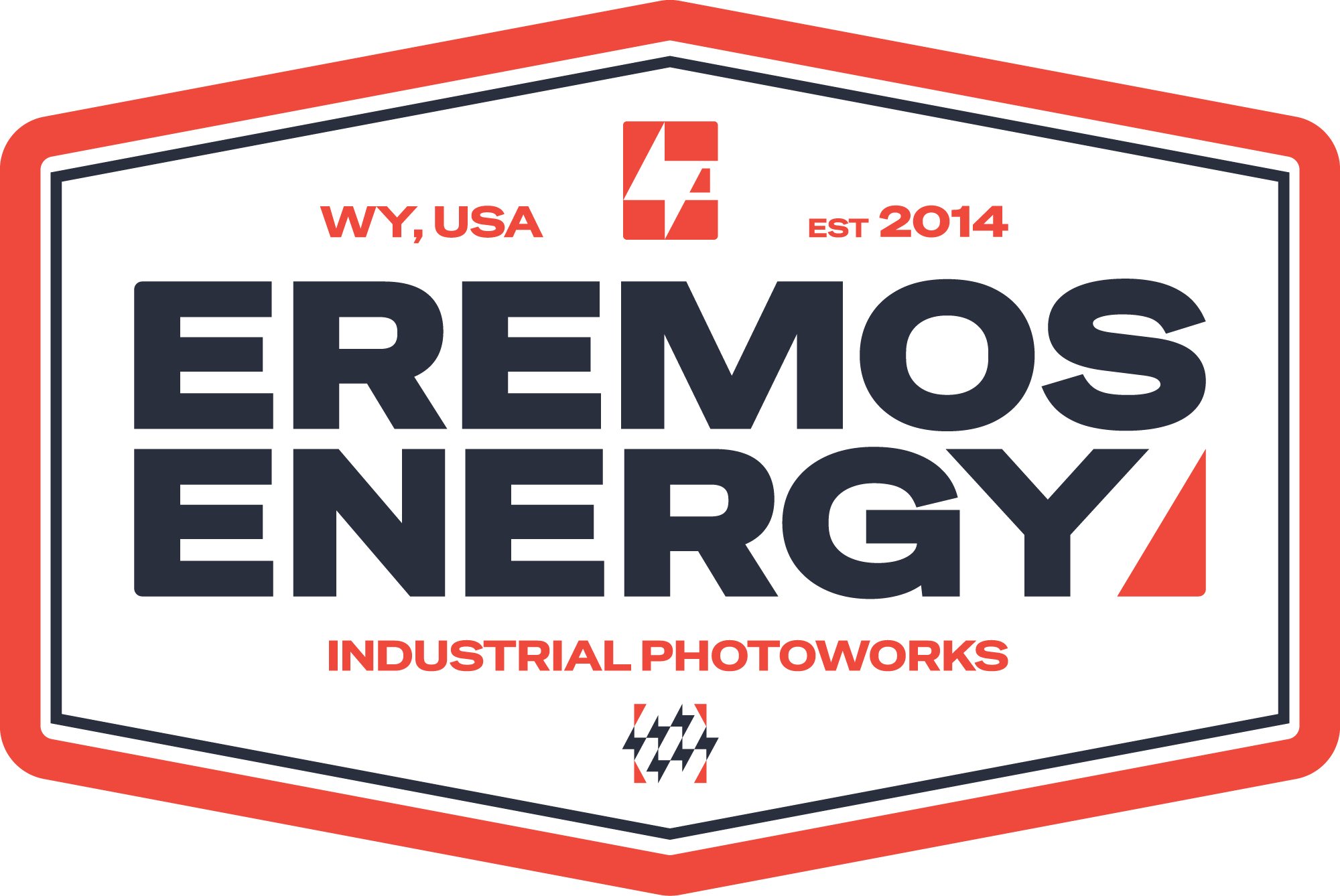 A graphic logo with the text "Eremos Energy" in large, bold letters. The logo has a shield shape with a red border, white background, and black and red accents. It includes the text "WY, USA" on the top left, "EST 2014" on the top right, and "Industrial Photoworks" at the bottom. The center features a stylized red and white geometric logo.