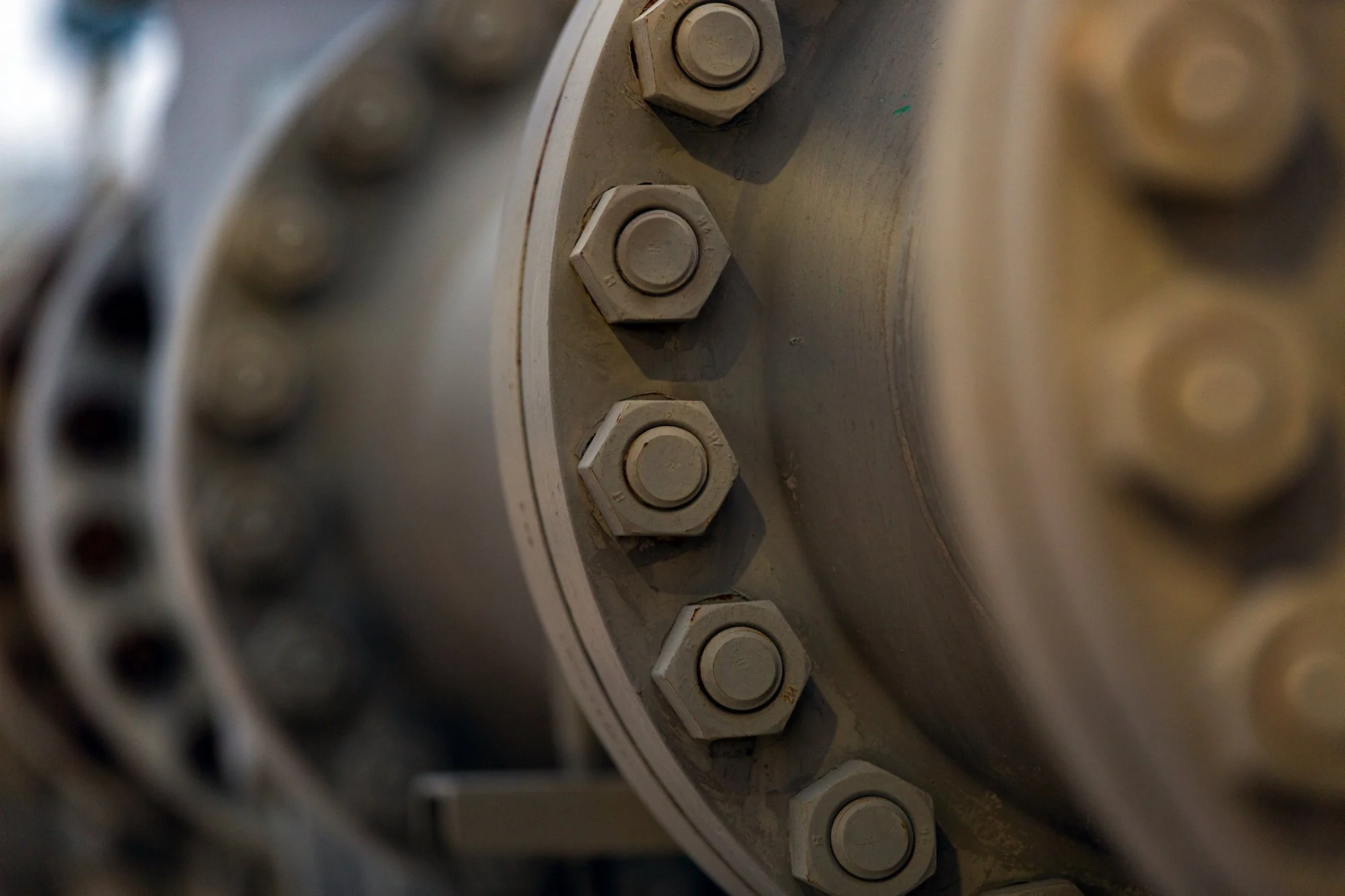 Close-up of a large industrial metal component with visible bolts and fasteners.