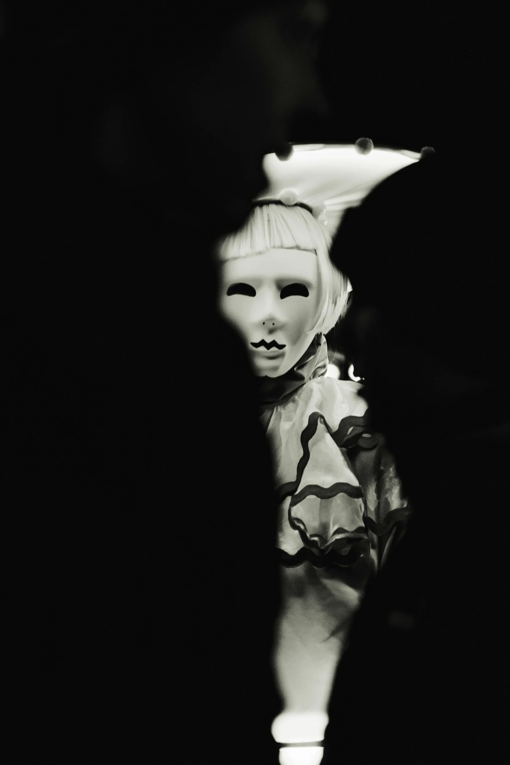Black and white photo of a puppet with a clown-like face, wearing a ruffled outfit, in a dark setting with minimal lighting.
fantasy ghostwriting
fantasy novel
worldbuilding
epic fantasy
fantasy author