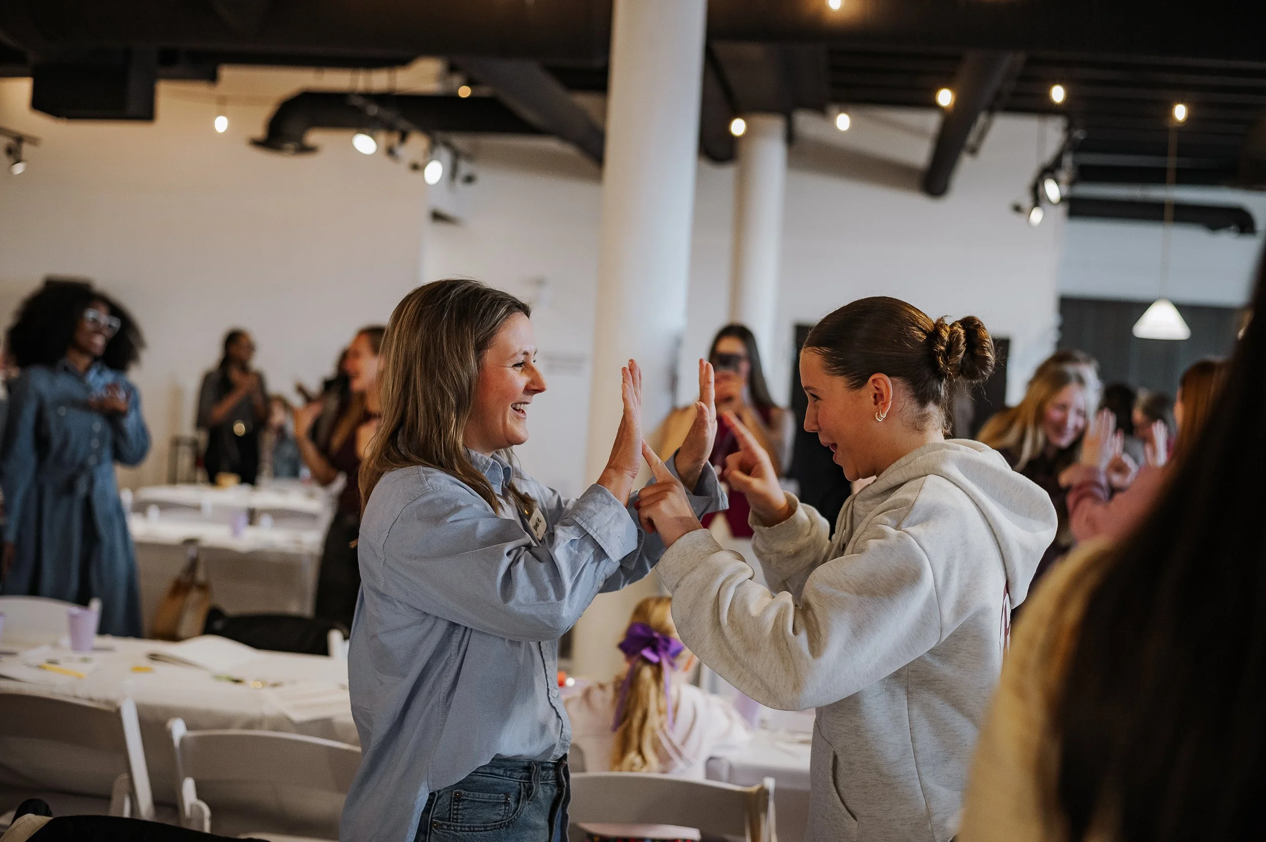 Mom and daughter high fiving