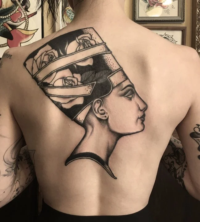 Tattoo of a woman in profile.