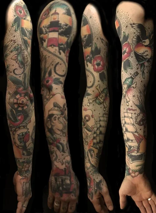 Tattooed arms with nautical themes, including a lighthouse, ship, compass, and flowers.