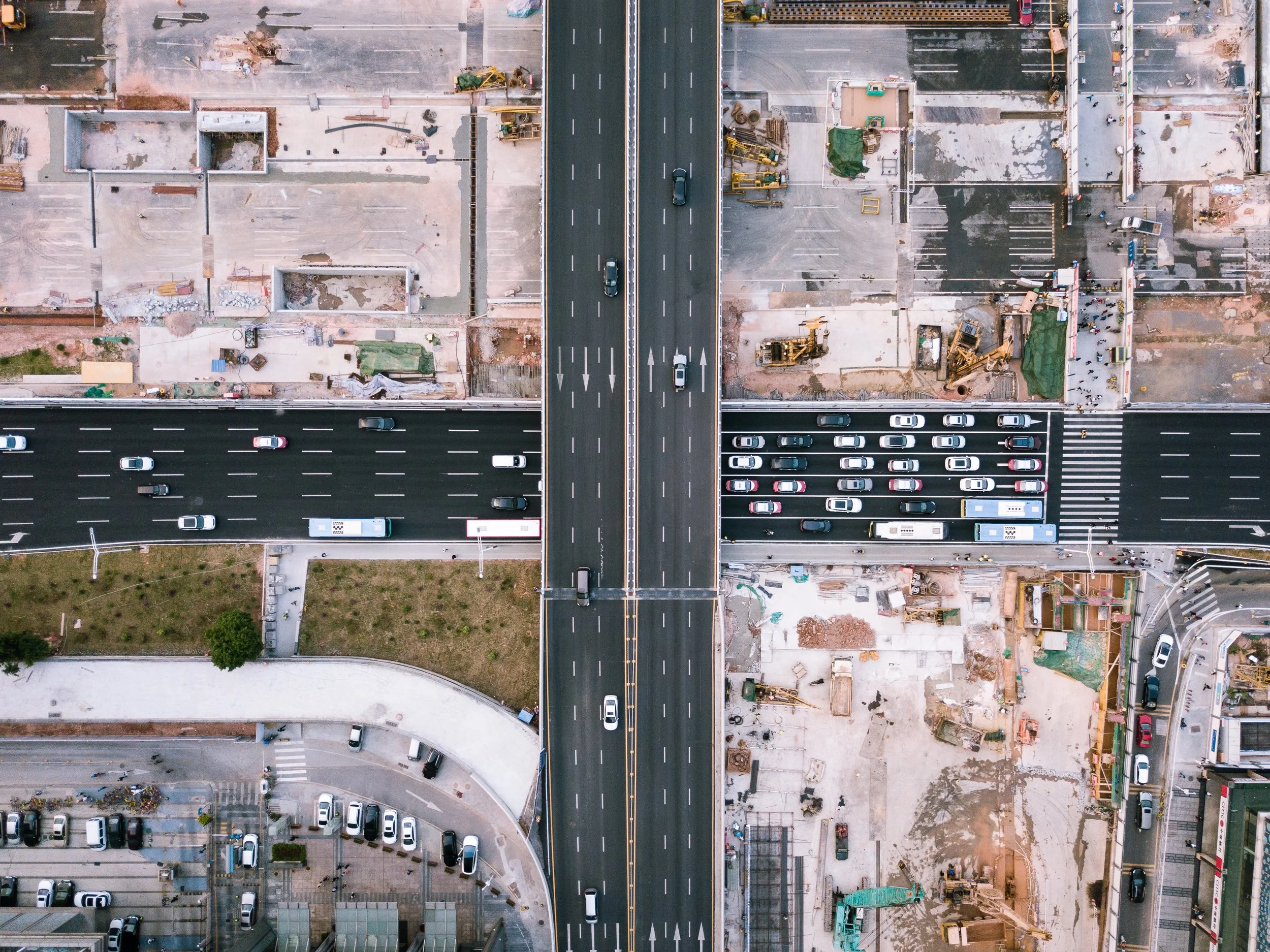 Drone shot of motorway with construction on the sides