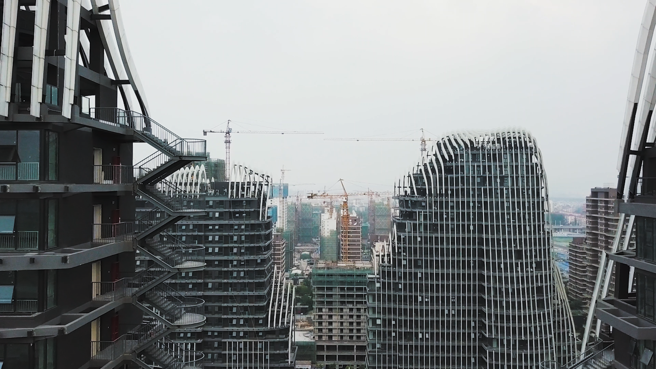 Building getting built with cranes around it