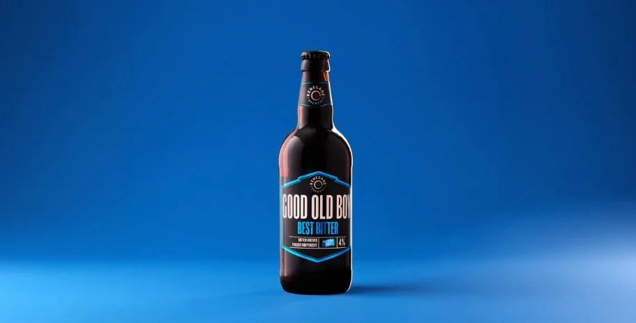 A bottle of Renegade Brewery Good Old Boy Best Bitter on a solid blue background, commercial drinks product photography by Alex Gell.