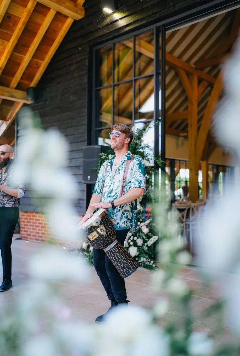 Live bongo player performing at a barn wedding reception by Alex Gell Photography.