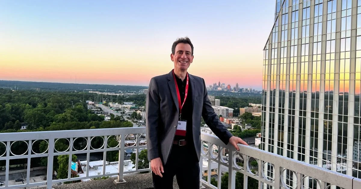 Photo of Dr. Gregory Charlop, MD, DipABLM, on the balcony of the Presidential Suite at the Grand Hyatt in Buckhead, Atlanta. He's there to speak at a conference of fitness professionals