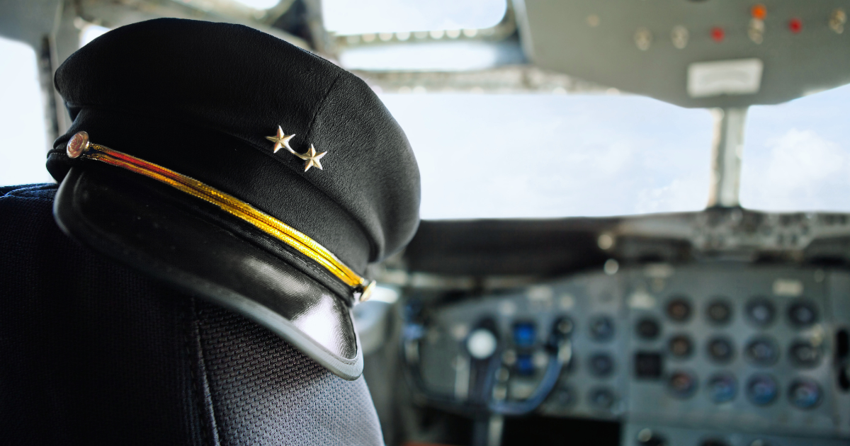 Imgage of a airplane cockpit with a pilot's uniform