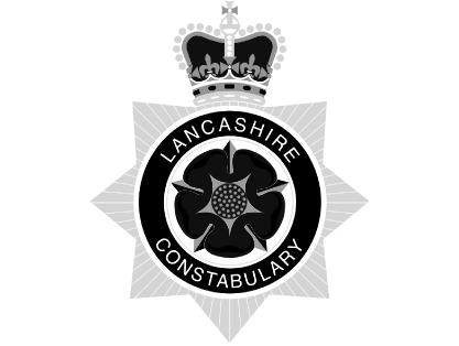 Lancashire Constabulary badge with a crown on top, featuring a black and white design.