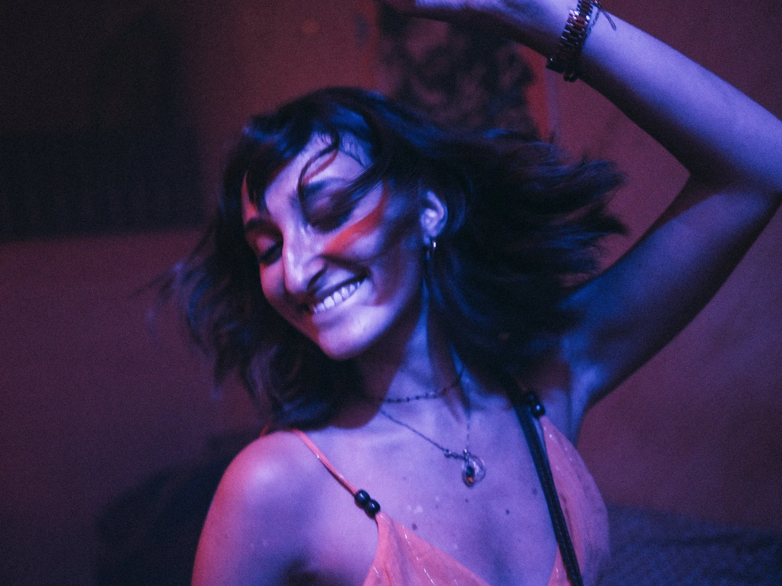 Woman smiling and dancing on night out