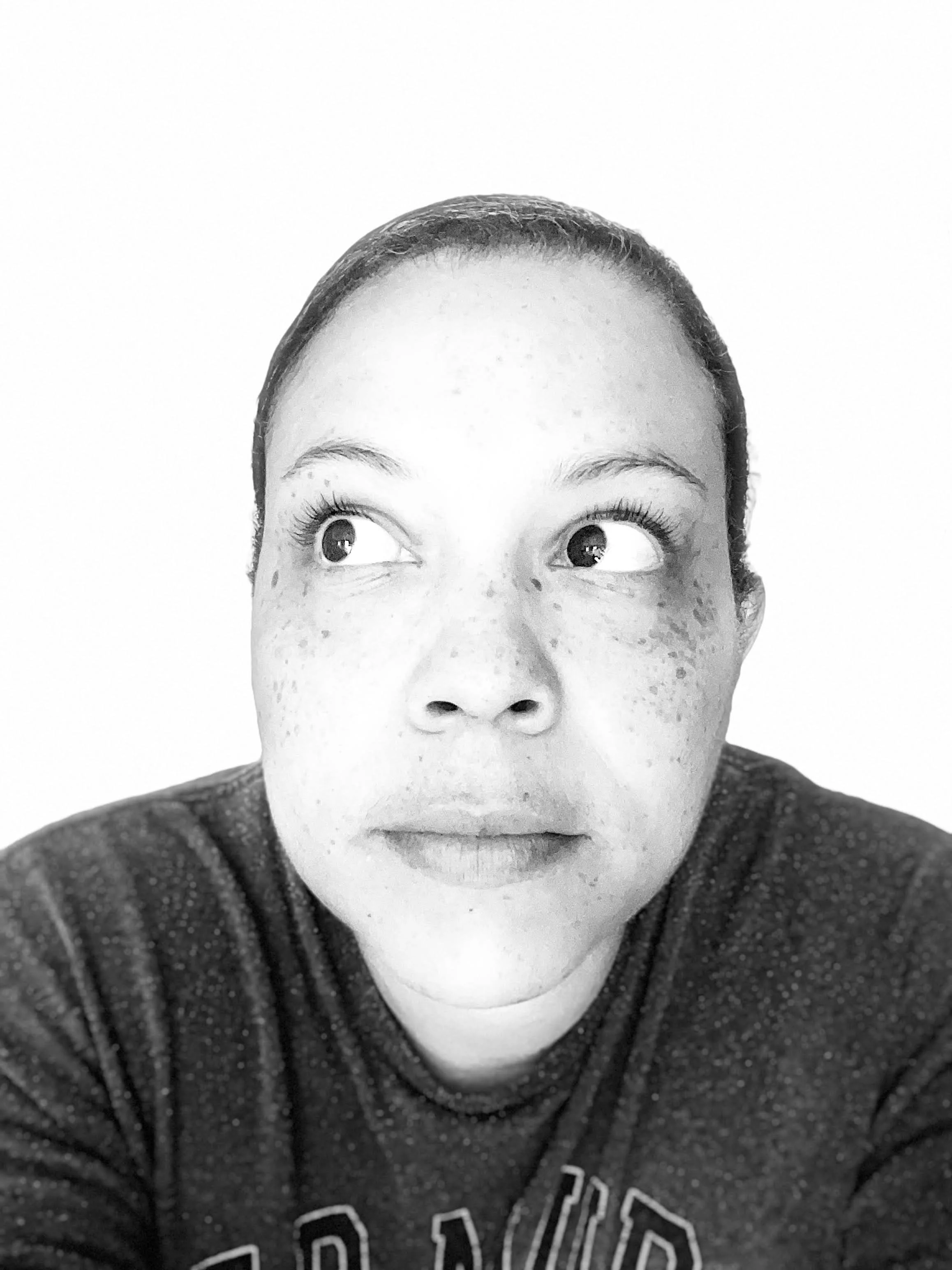 Black-and-white close-up portrait of Stephanie Todd looking upwards to one side, against a light background.