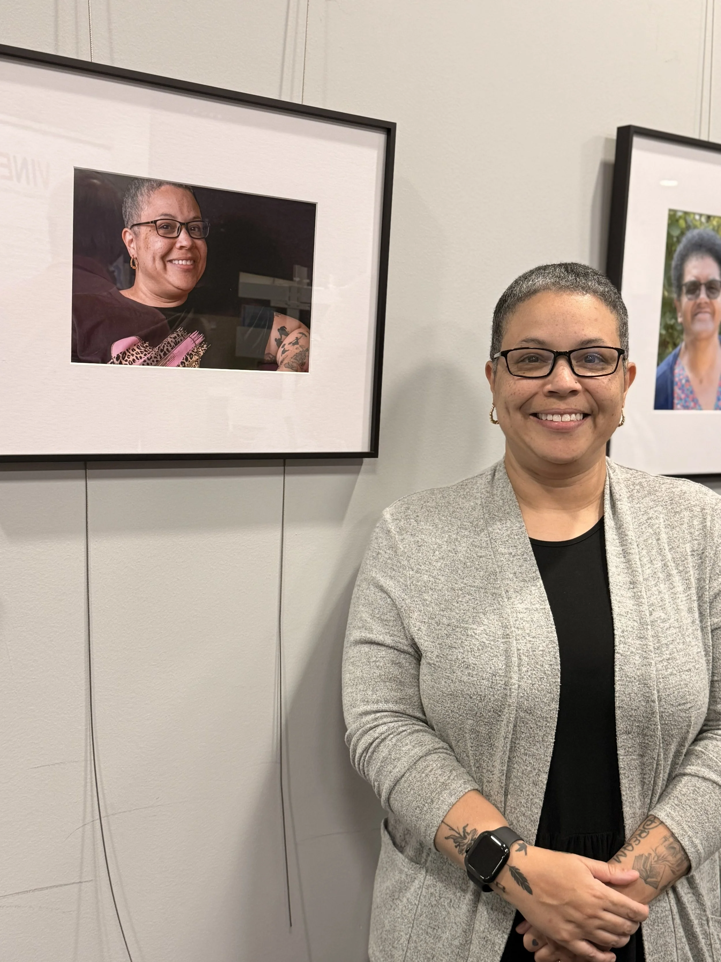 Stephanie Todd smiling beside her framed portrait at Wokingham Borough Council's Black History Month exhibition in October 2026.